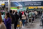 Passengers queue to check in at London Heathrow Airport in April. 