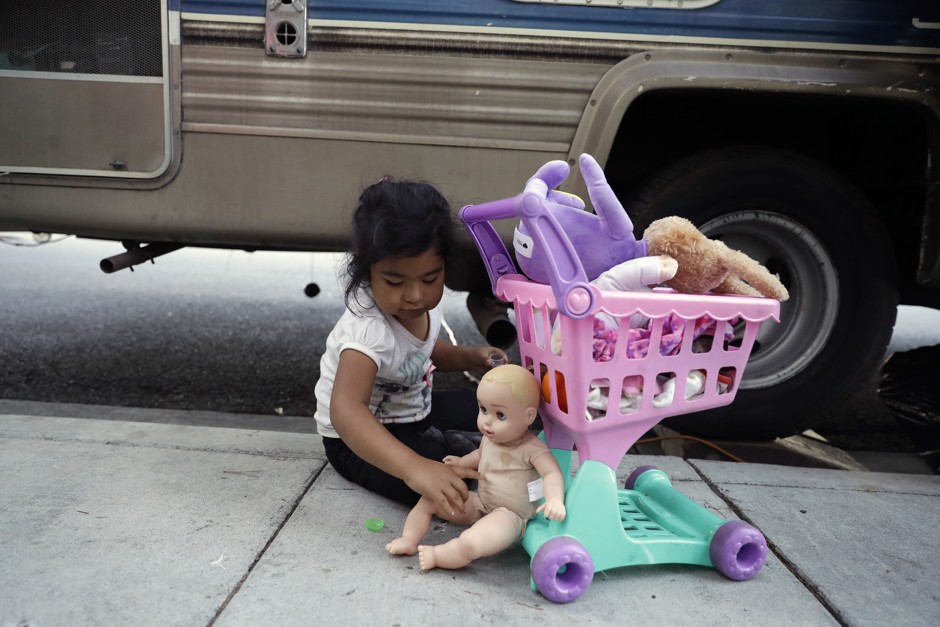 Delmi Ruiz Hernandez, 4, top, plays outside of an RV where her family lives in Mountain View, California.