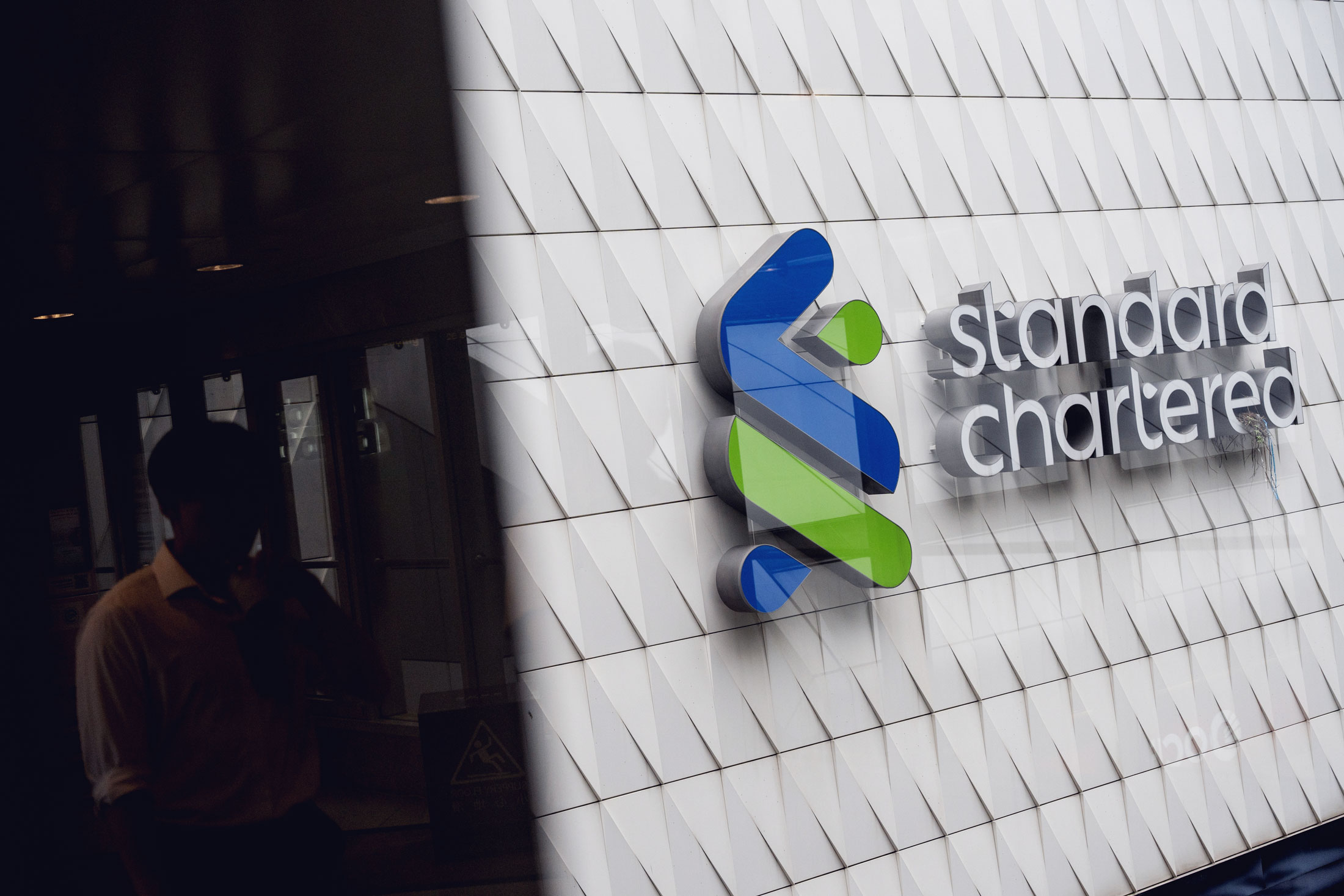 Signage at a Standard Chartered Plc bank branch. Photographer: Chan Long Hei/Bloomberg