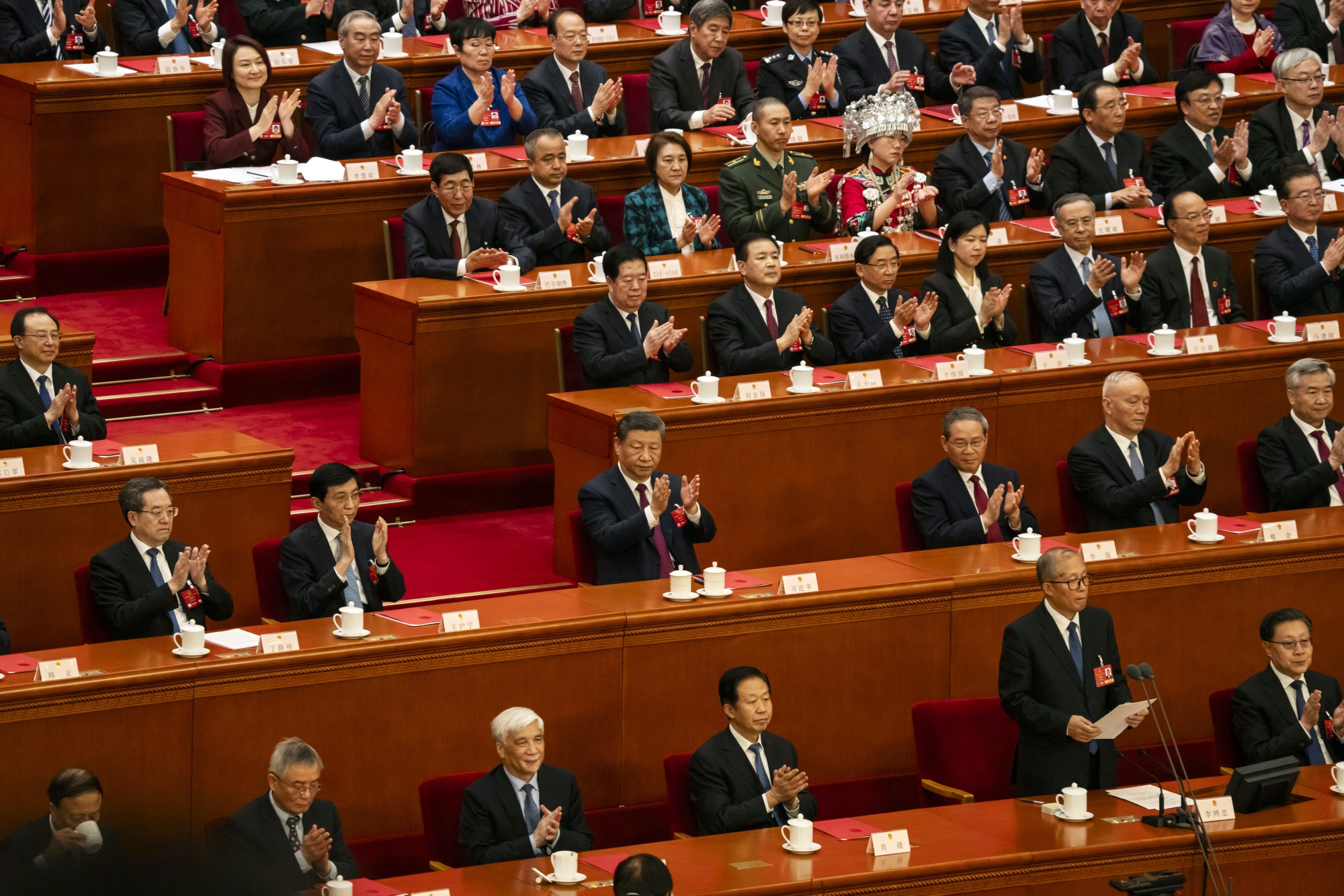 Xi Jinping, China's president, center, applauds during the closing of the Third Session of the 14th National People's Congress (NPC) at the Great Hall of the People in Beijing, China, on Tuesday, March 11, 2025. The seven-day National People's Congress gathering, which concludes today in Beijing, came on the heels of a breakthrough in artificial intelligence by China's home-grown startup DeepSeek that's fired up investors, politicians and even regulators. Photographer: Qilai Shen/Bloomberg