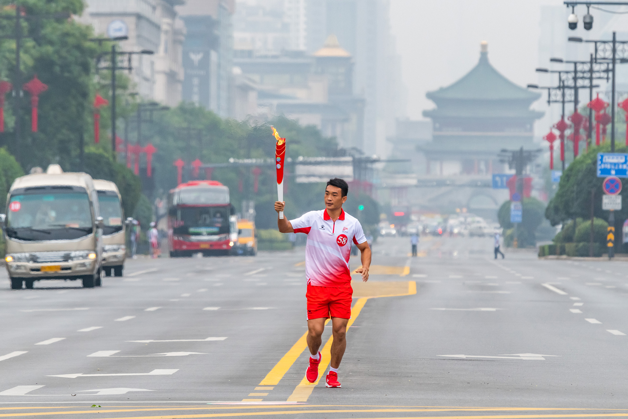 A torchbearer participates in the torch relay for China’s 14th National Games in Xi’an, on Aug. 16.