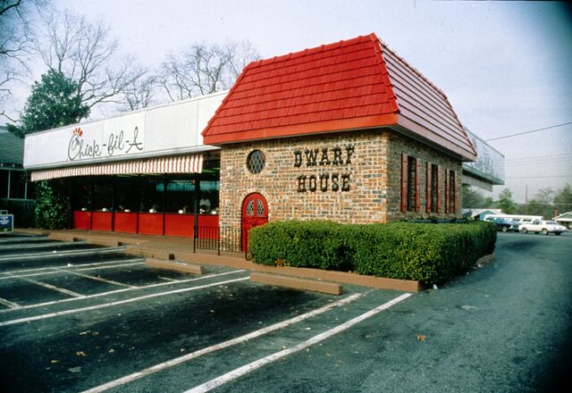 An exterior photo of the The Dwarf House, a brick building with a red roof. 