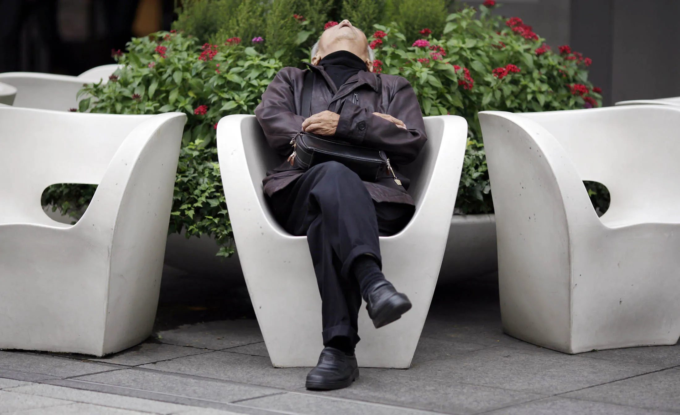 A man takes a nap in Tokyo.
