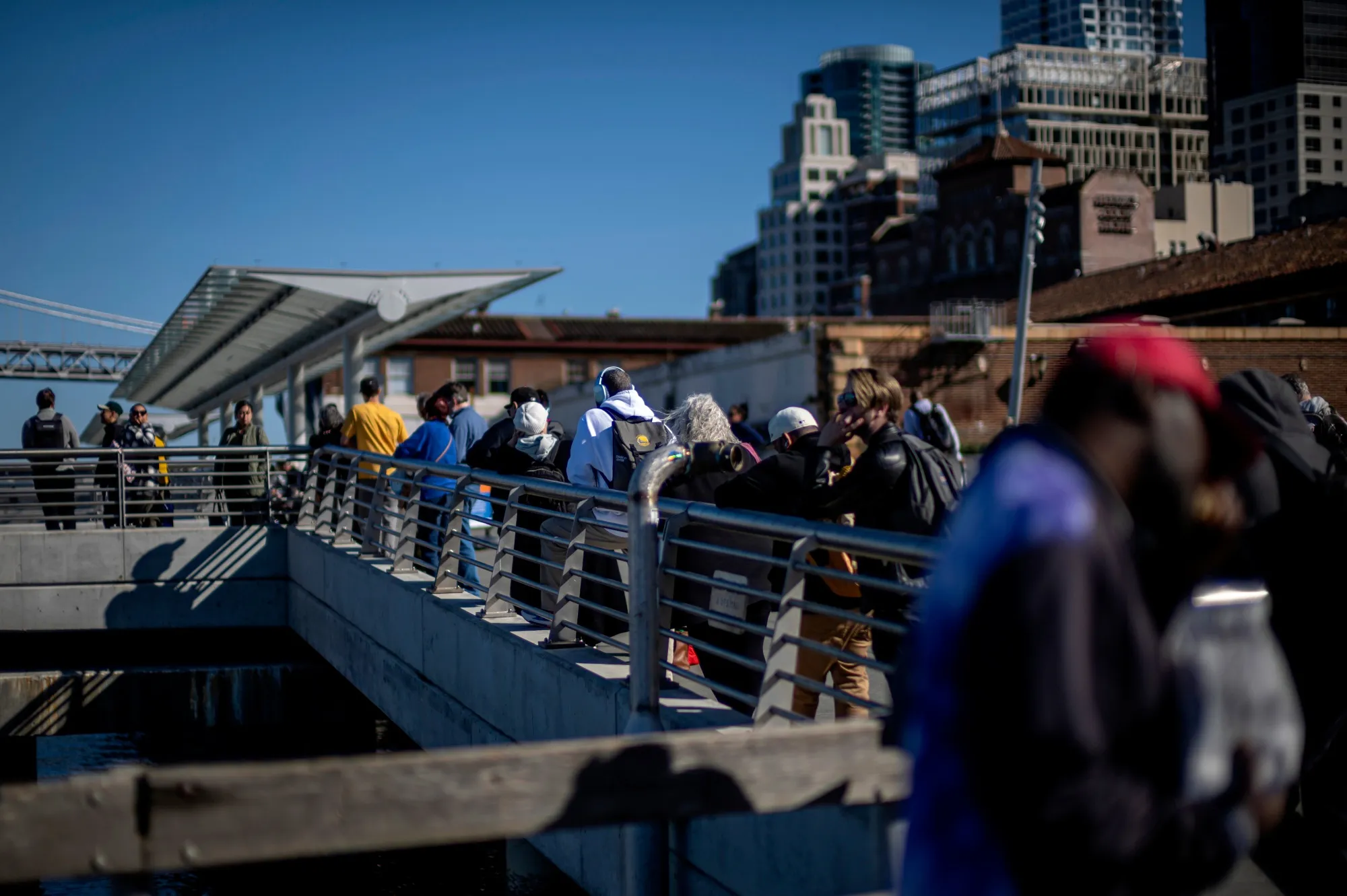 Commuters wait to board a SF Bay Ferry in San Francisco, California.