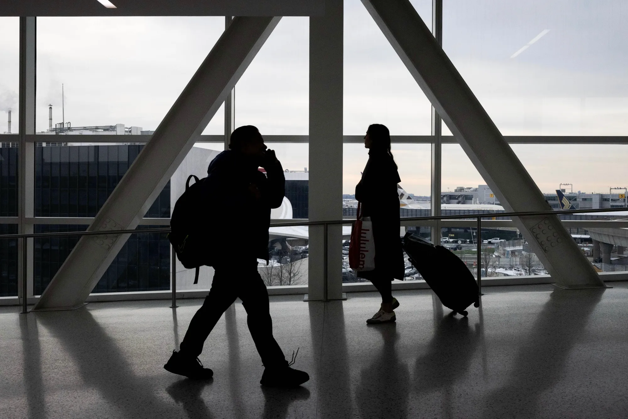 Travelers at John F. Kennedy International Airport in New York.