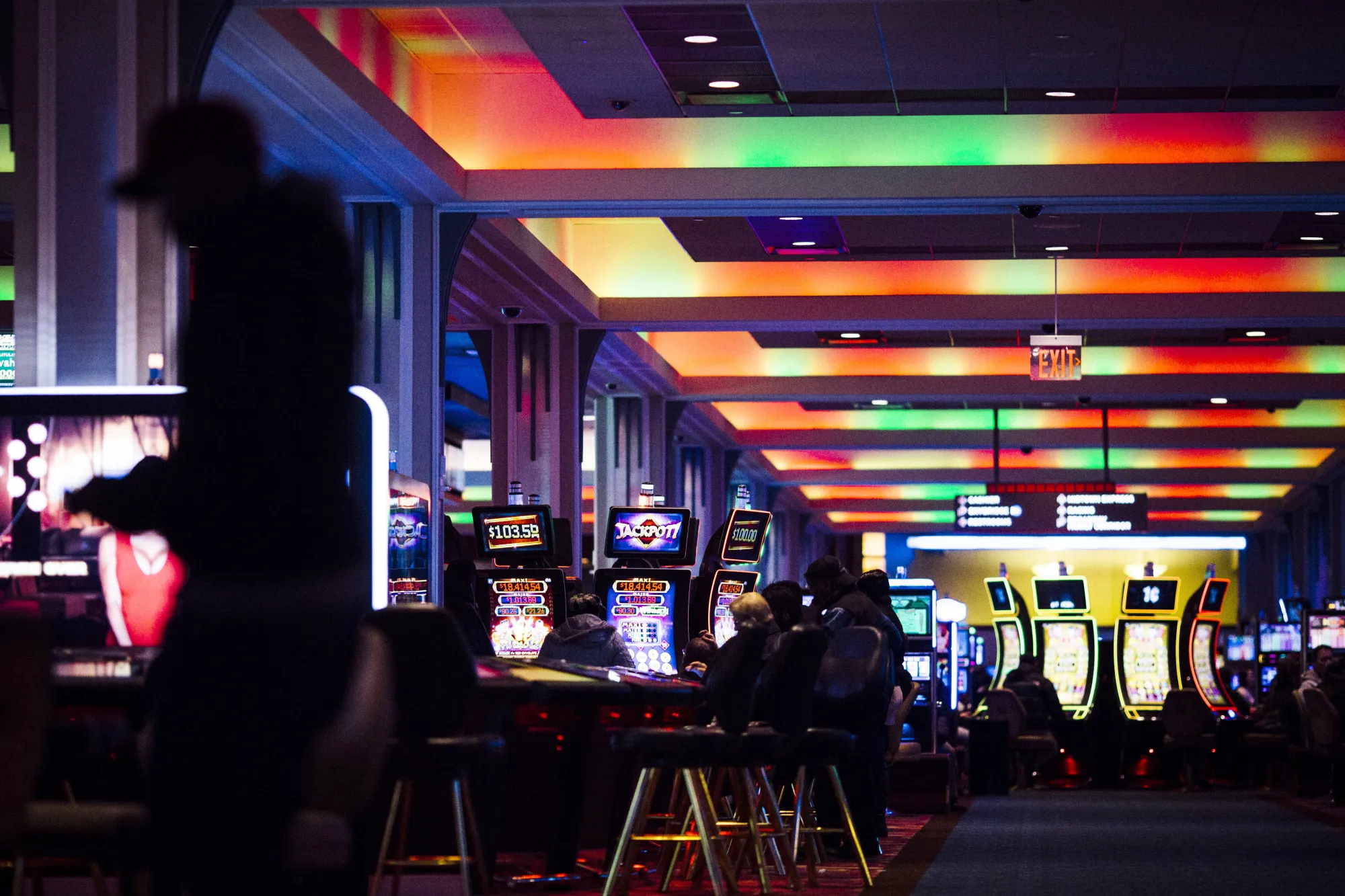 Customers play at gambling machines at the Resorts World Casino, operated by Genting Group, in Queens, New York.