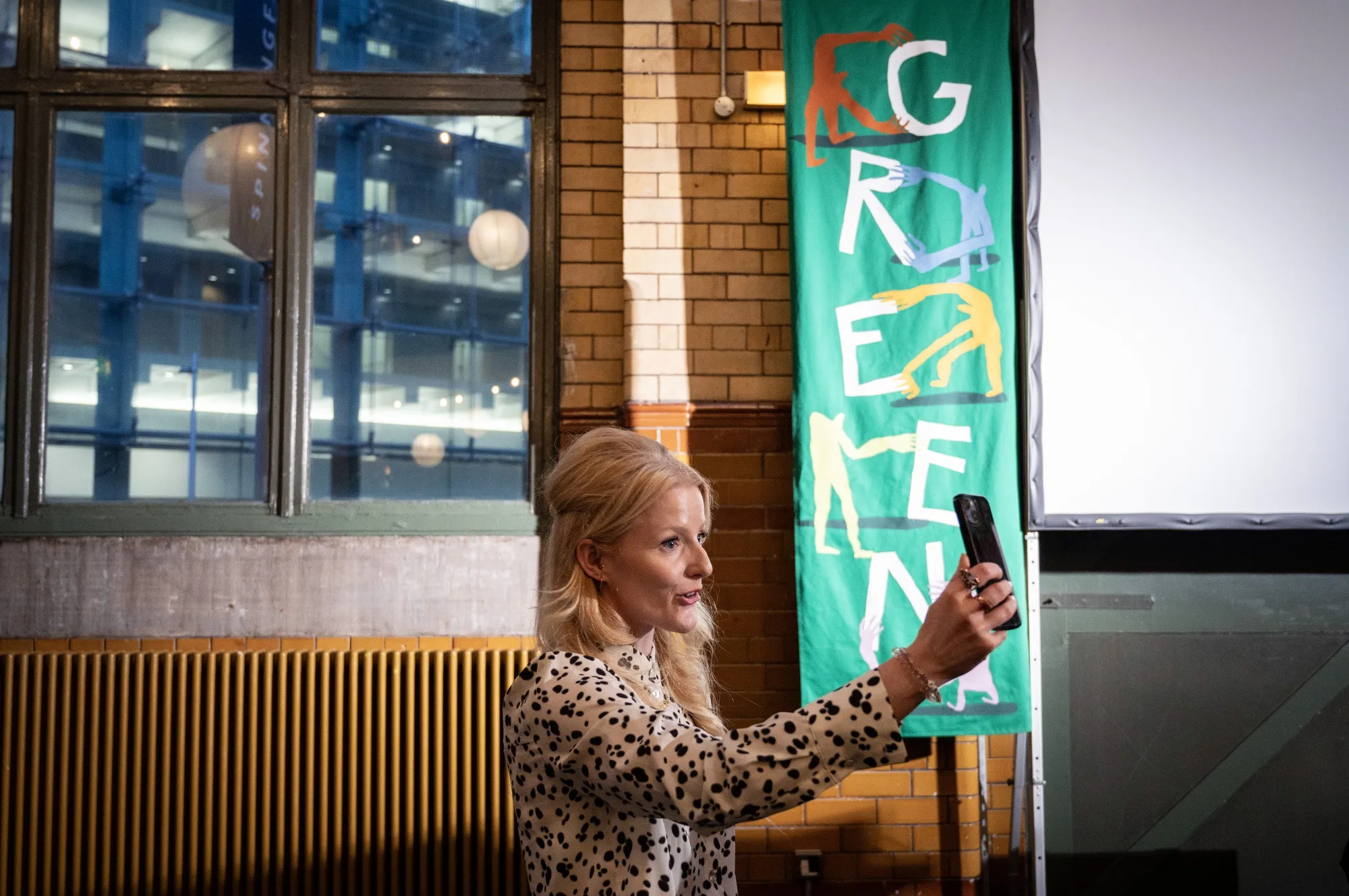Hannah Spencer, UK lawmaker, makes a video call at the Green Party’s launch of Workers Charter of fundamental rights during a May Day Rally in Manchester, UK, on Friday, May 1, 2026.