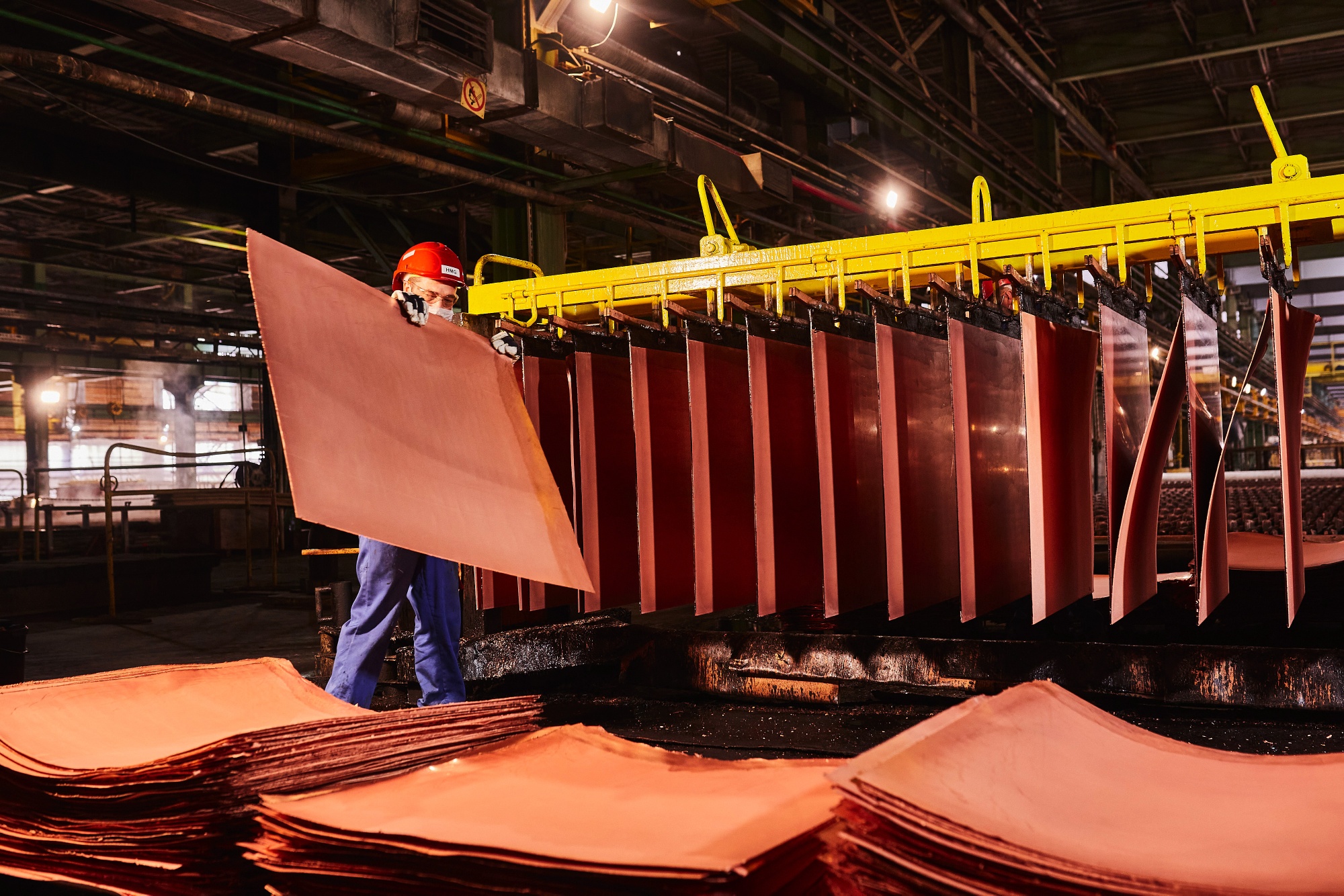 A worker handles newly formed copper cathode sheets in a warehouse at the KGHM Polska Miedz SA copper smelting plant in Glogow, Poland, on Tuesday, March 9, 2021. Nickel extended its plunge from a six-year high after a stock-market slump hurt risk appetite, while copper resumed losses as supply concerns eased. Photographer: Bartek Sadowski/Bloomberg