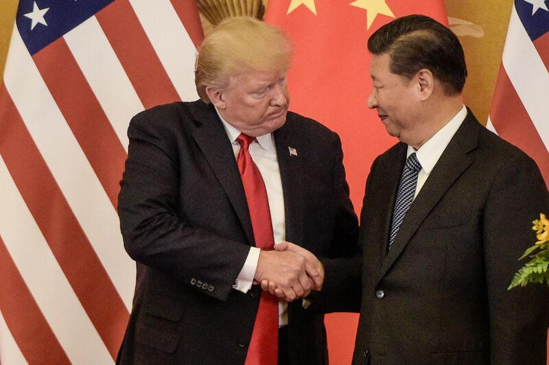 US President Donald Trump (L) shakes hand with China's President Xi Jinping at the end of a press conference at the Great Hall of the People on November 9, 2017. 