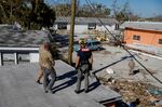 First responders walk on the debris of a house at the marina at San Carlos Maritime Park following Hurricane Ian in Fort Myers, Florida on Sept. 30.