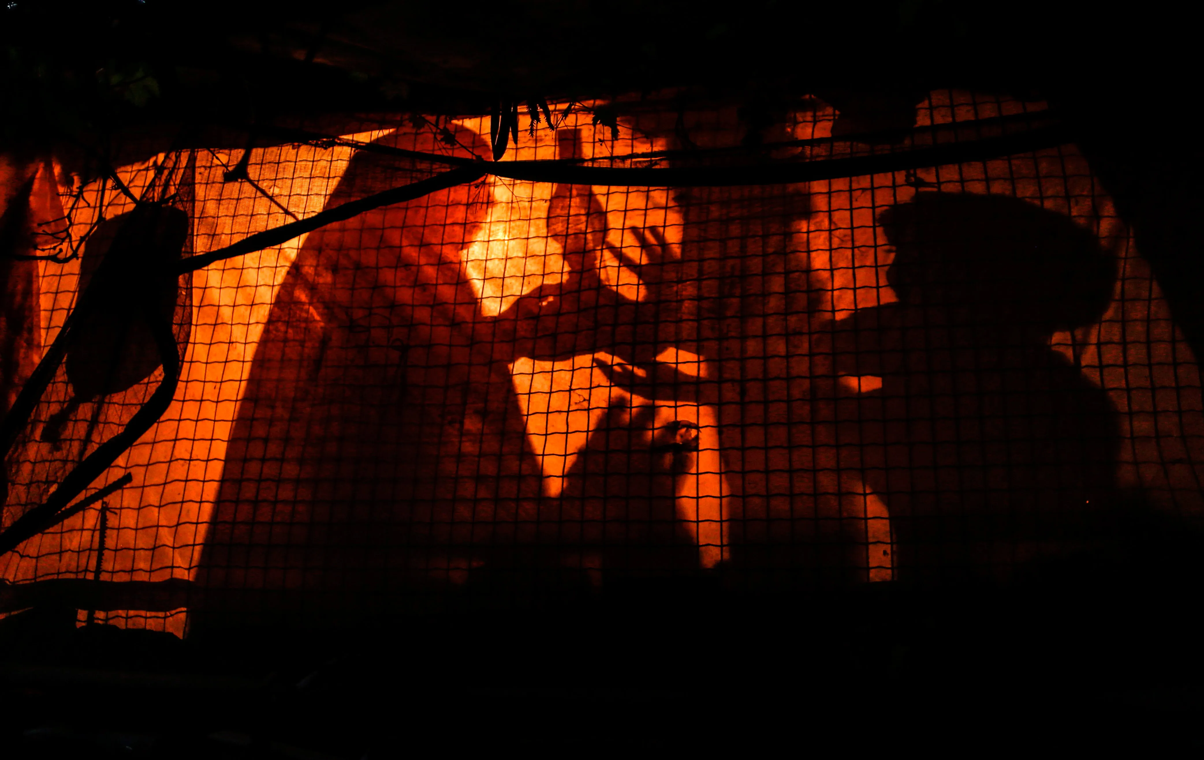 A Palestinian woman uses a gas lamp during a power cut in the Gaza Strip.