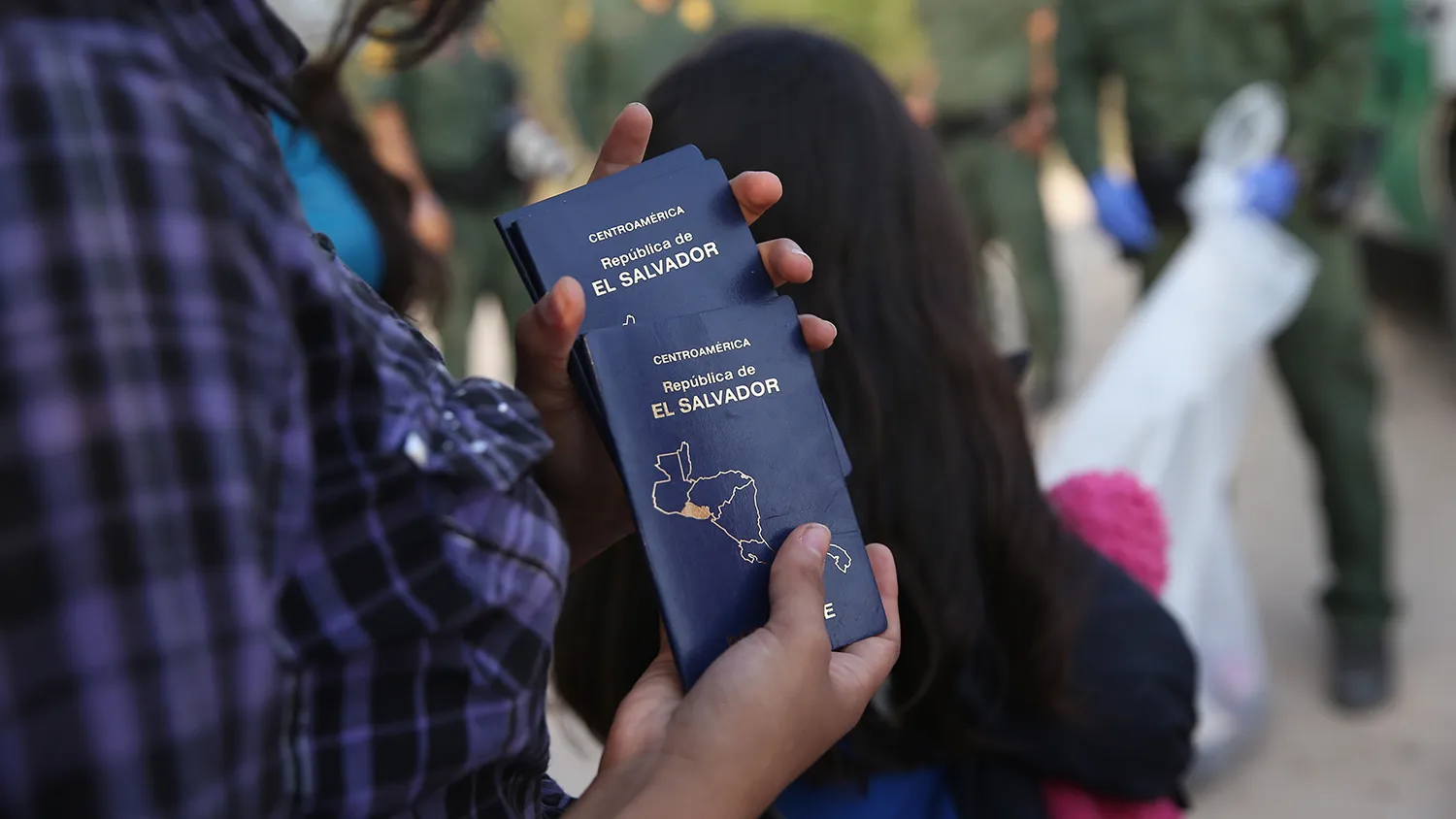 A Salvadorian minor carries her family's passports after crossing the Rio Grande from Mexico into the United States on July 24, 2014 in Mission, Texas.
