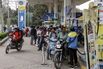 People line up at a gas station in Varanasi, India.