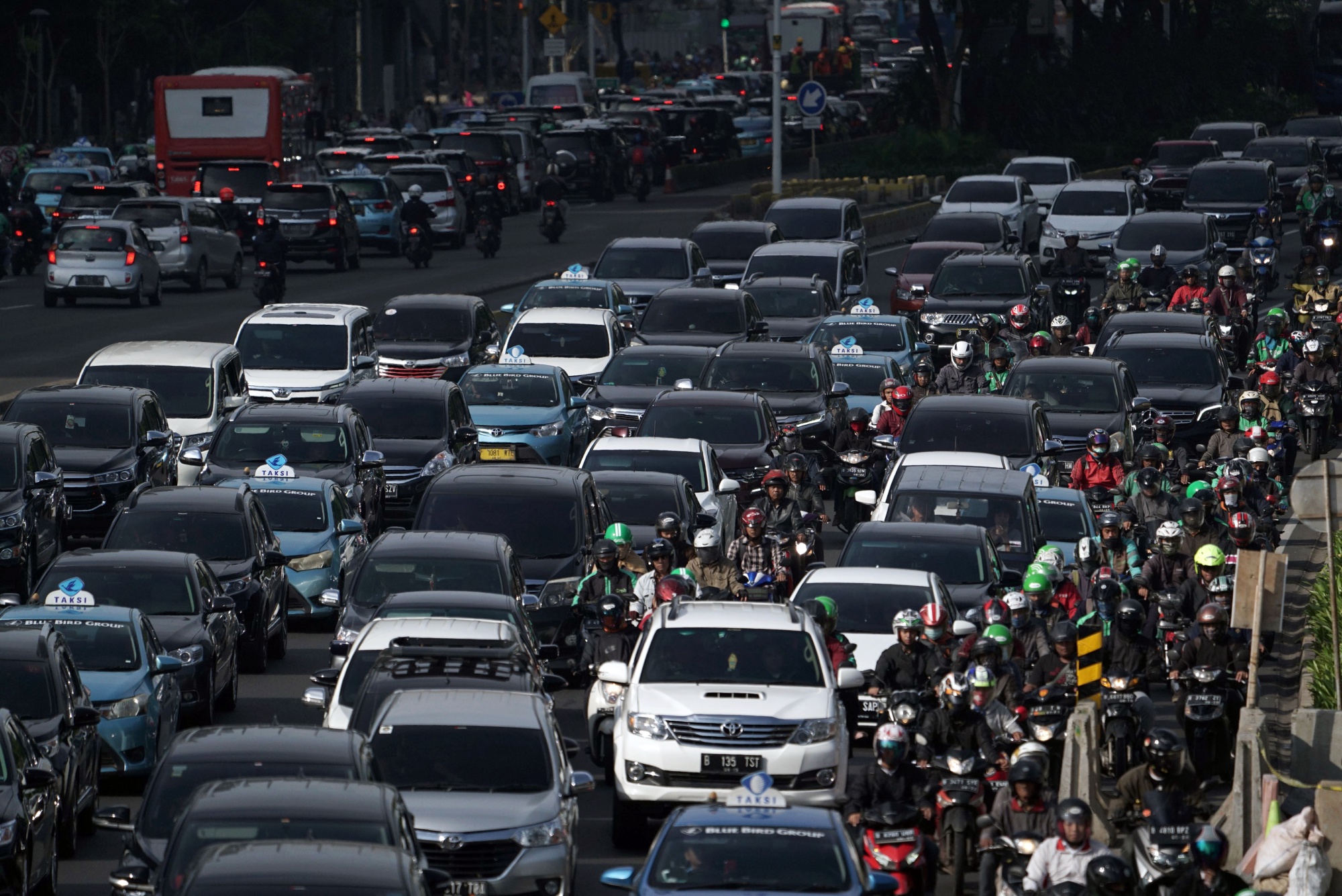 Vehicles travel along a road in Jakarta.