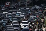 Vehicles travel along a road in Jakarta.