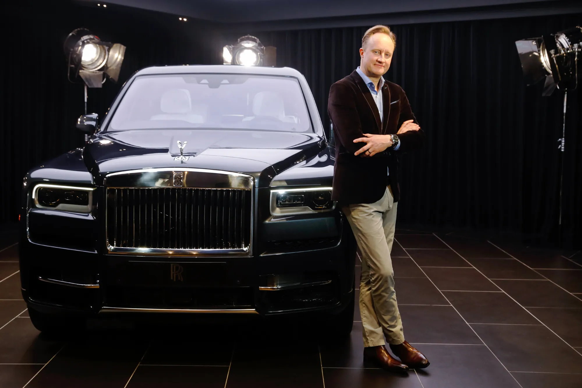 Giles Taylor stands with a Rolls-Royce Cullinan SUV.