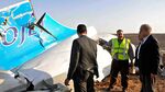 Egyptian Prime Minister Sherif Ismail, right, looks at the remains of a crashed Russian passenger jet in Hassana, Egypt, on Oct. 31, 2015.
