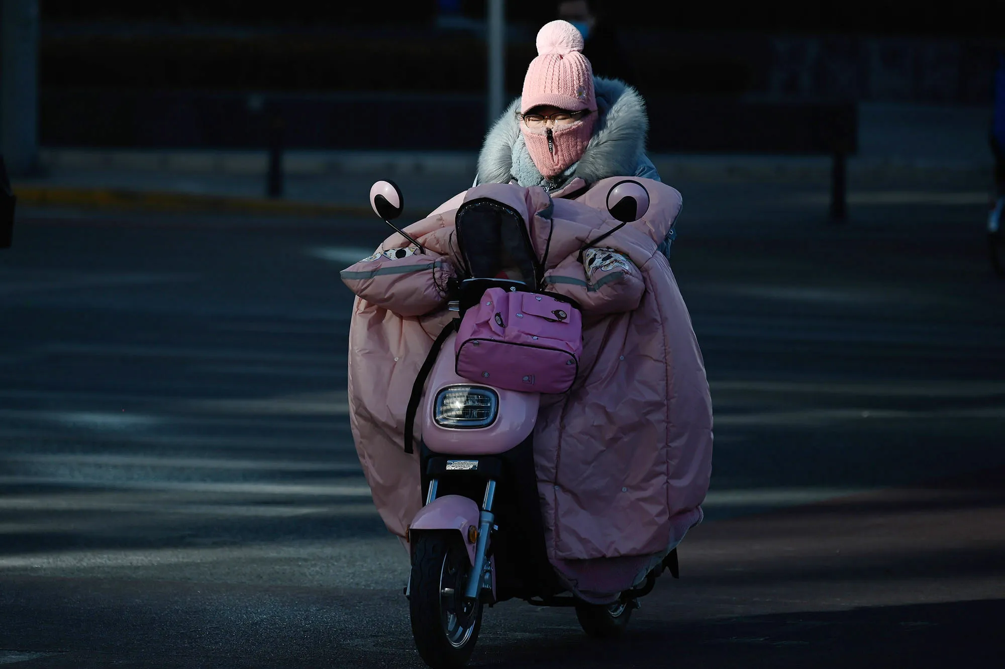 A woman wrapped up for the cold rides in Beijing on Jan.&nbsp;8.&nbsp;