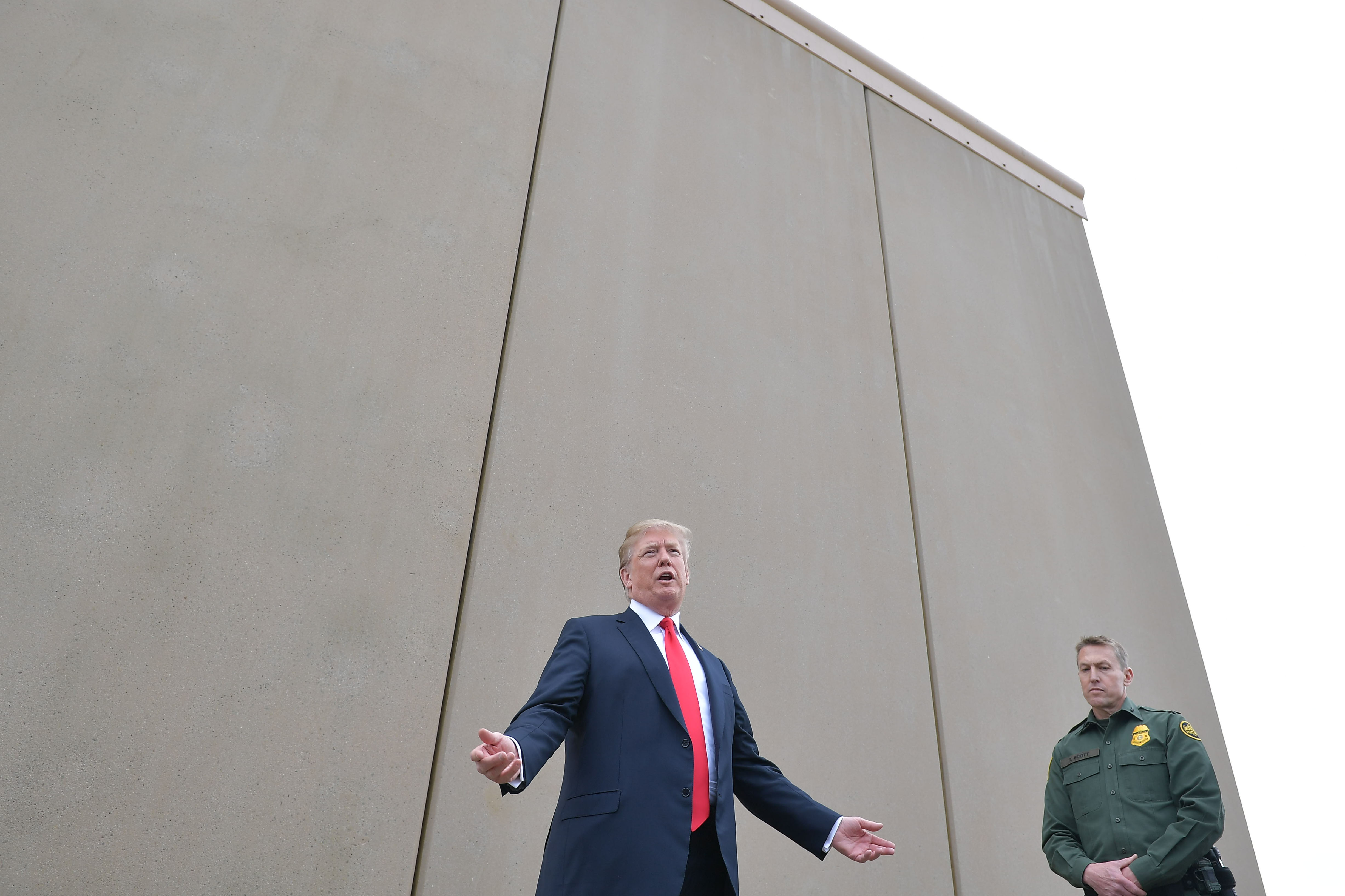Performance art: the president with a prototype of his border wall last year.