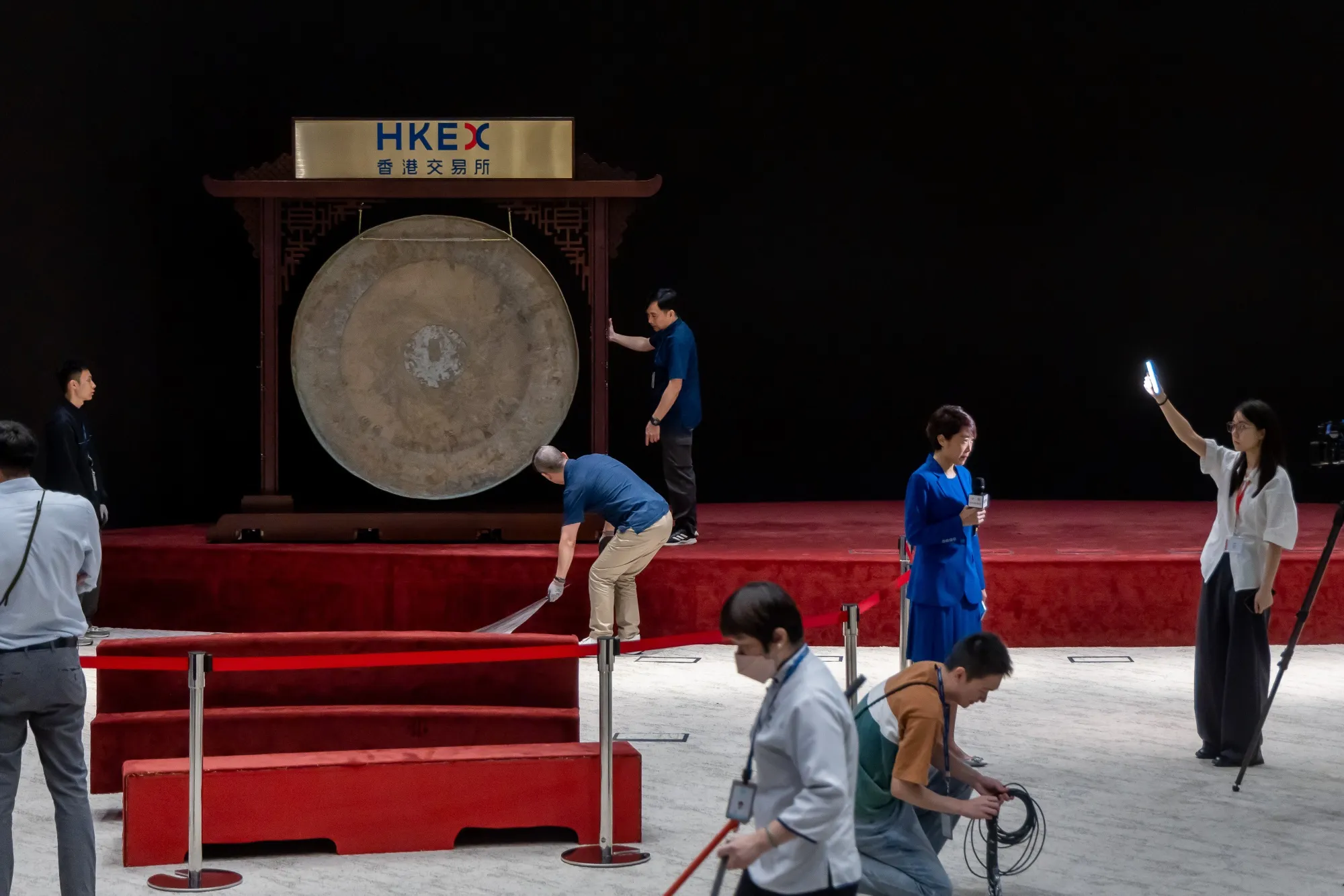 Workers move a gong ahead of a listing ceremony at the Hong Kong Stock Exchange.