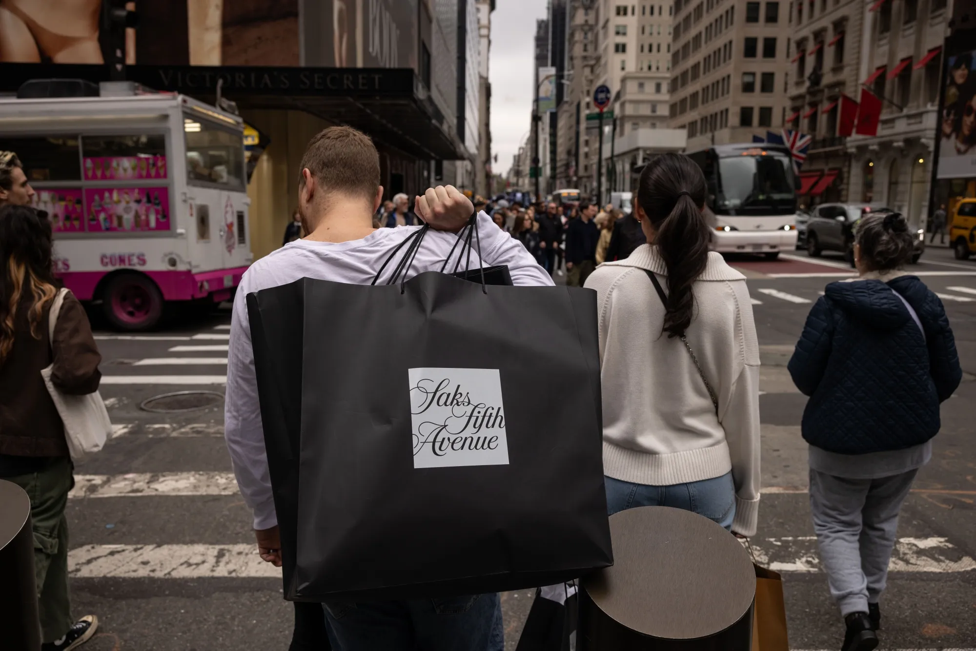 A shopper carries a Saks Fifth Avenue.