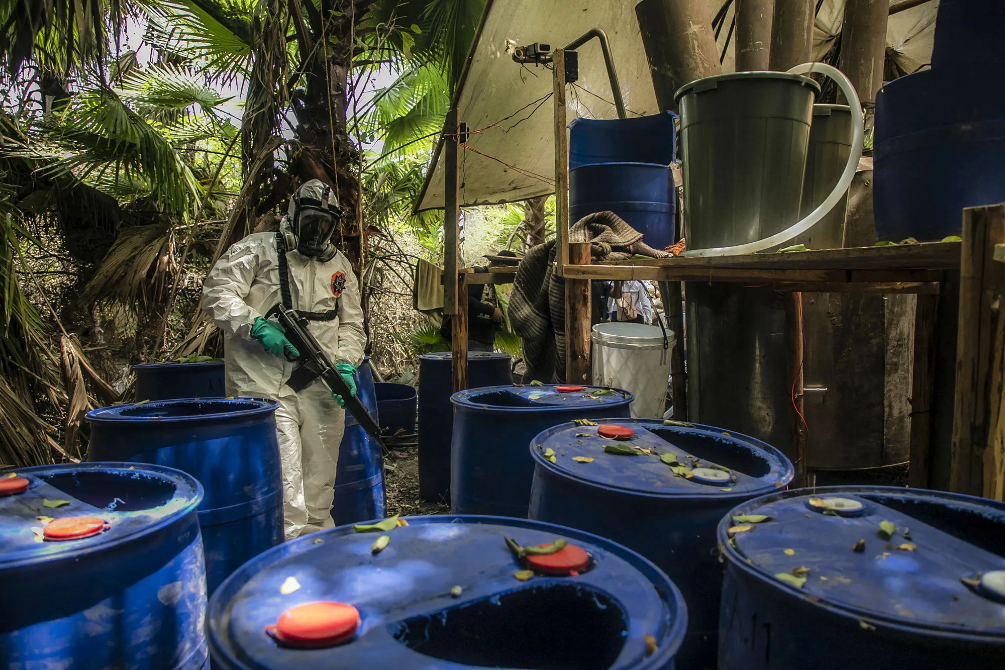 A&nbsp;police officer looks over a&nbsp;synthetic drug lab during dismantling of the site, in El Dorado, Mexico.