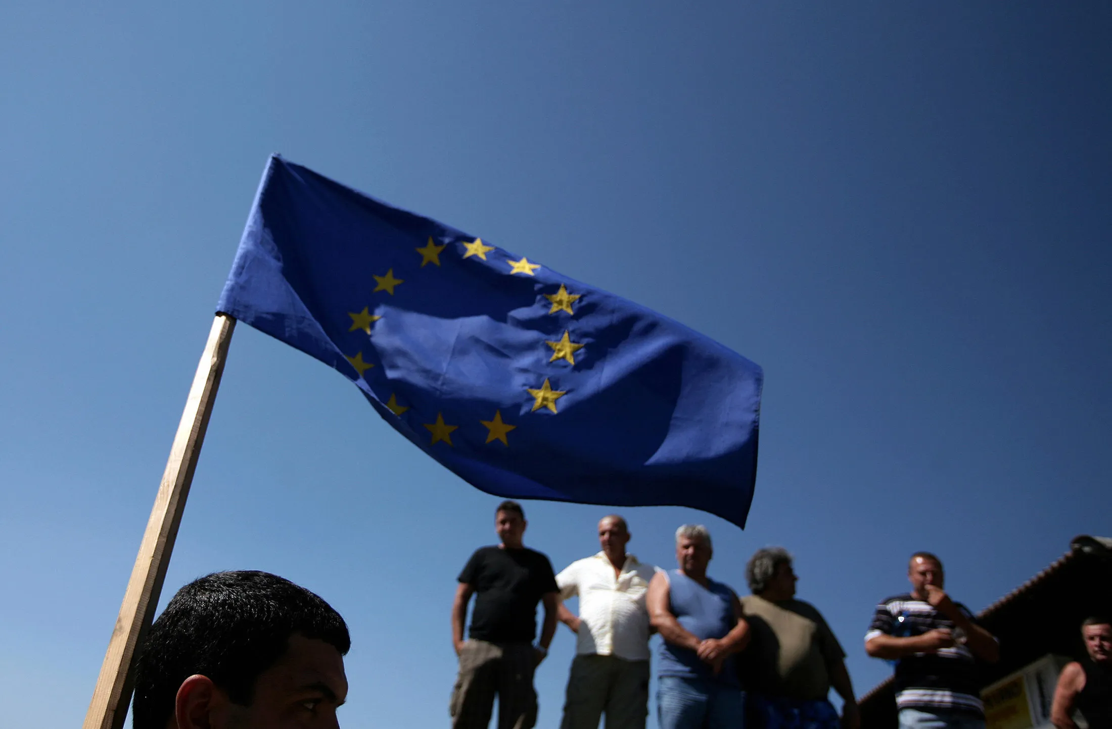 A Bulgarian farm producer holds an EU flag.&nbsp;