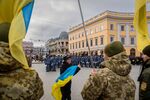 A member of the public waves a Ukraine flag at a rally attended by soldiers and police in Odessa, Ukraine.