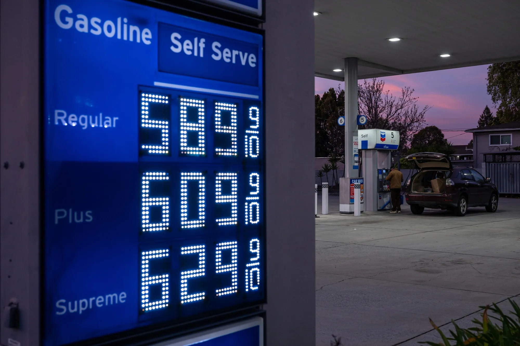 A sign displays the prices of unleaded gasoline at a Chevron gas station in Palo Alto, California.