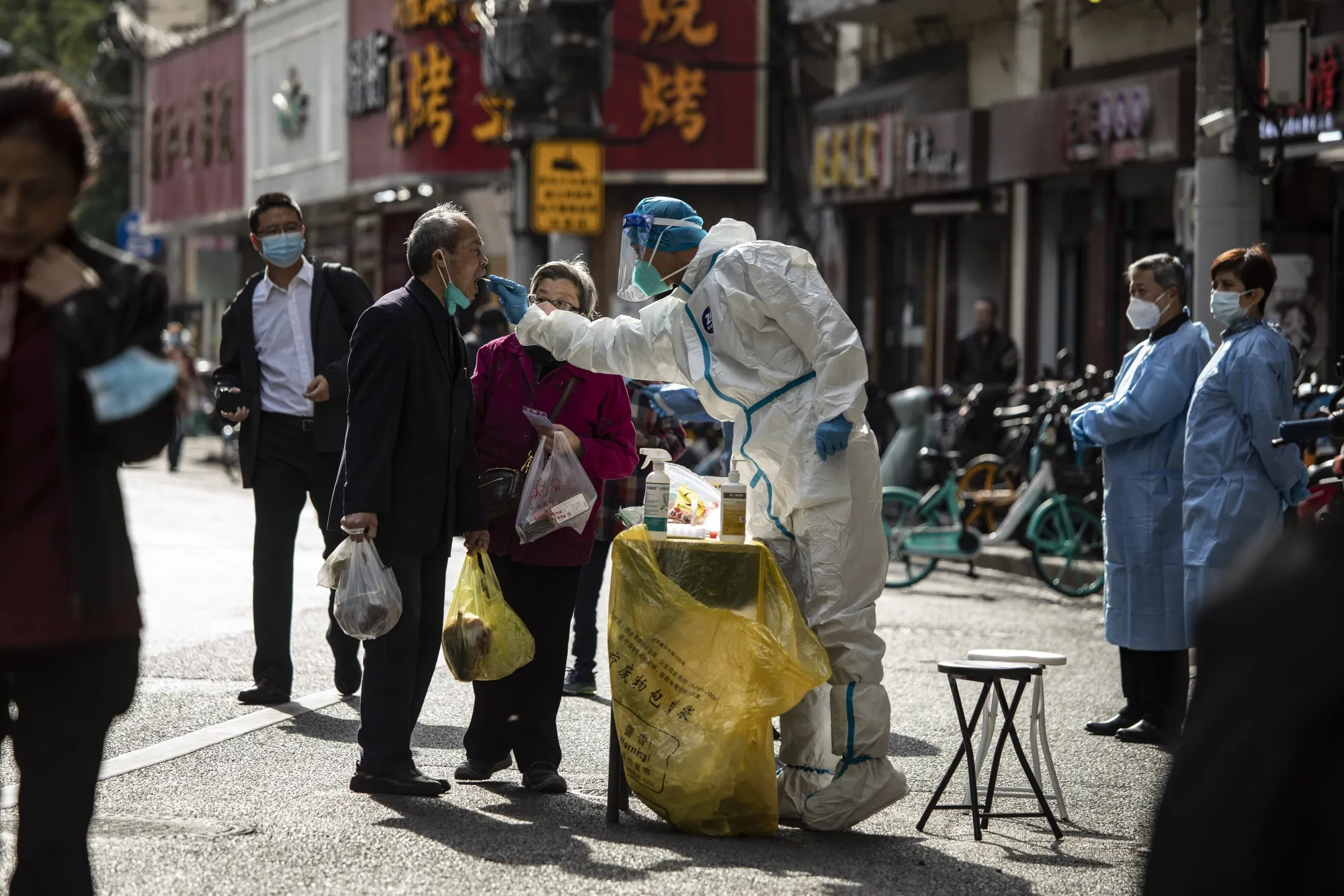 A healthcare worker&nbsp;collects swab sample from a resident for a Covid-19 test in Shanghai, China, on&nbsp;Nov. 6.&nbsp;