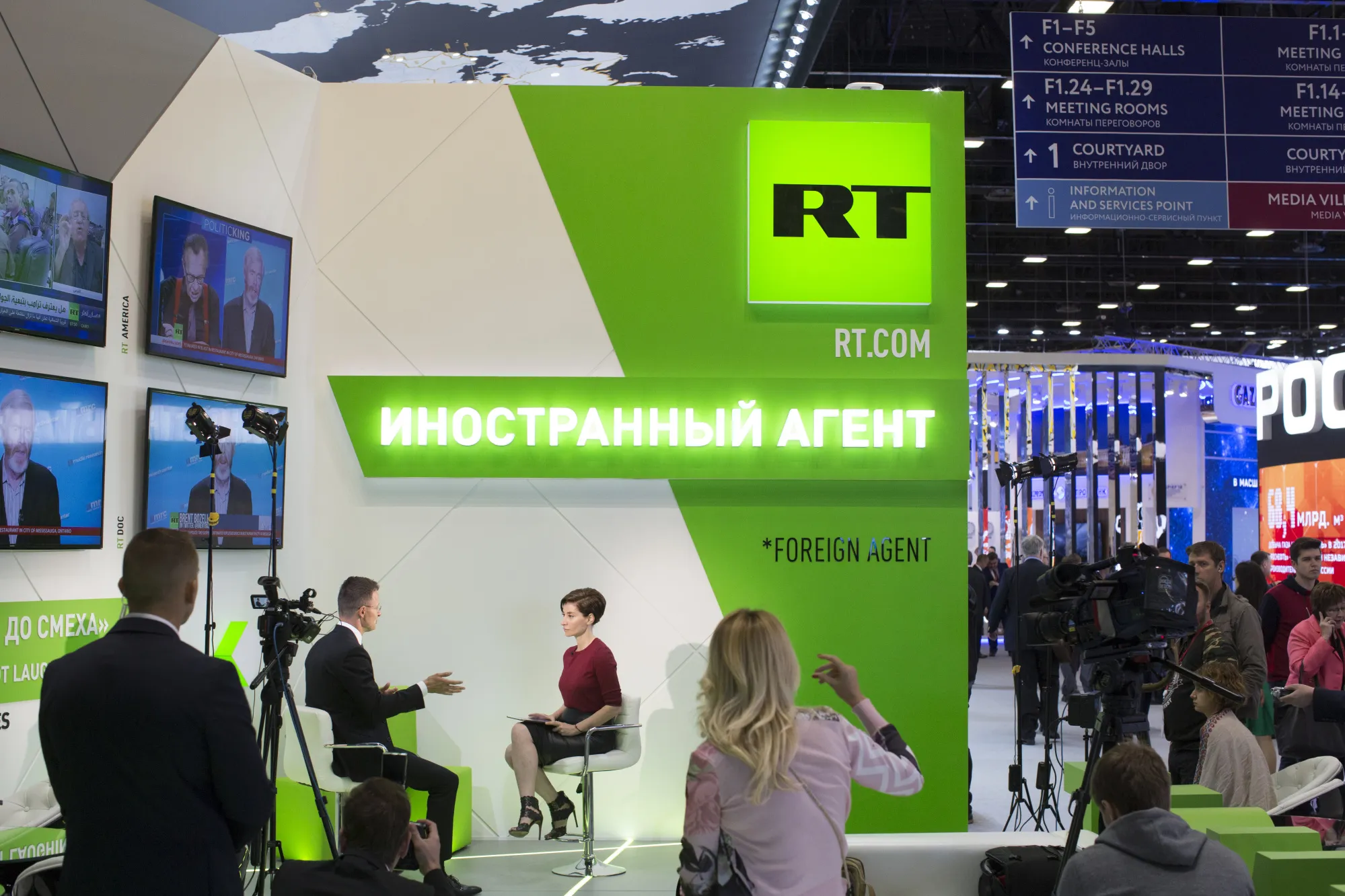 A television broadcaster interviews a guest on the set of RT.com at the St. Petersburg International Economic Forum in St. Petersburg, Russia.