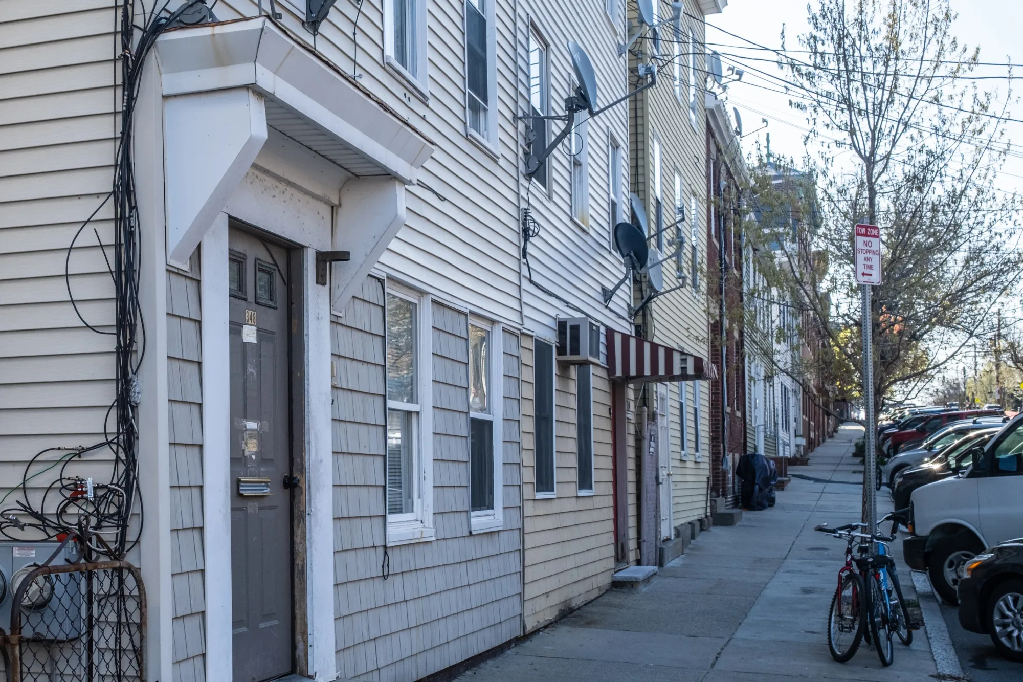 The three-unit rental, left, that landlord Joaquin Villanueva owns in Boston.