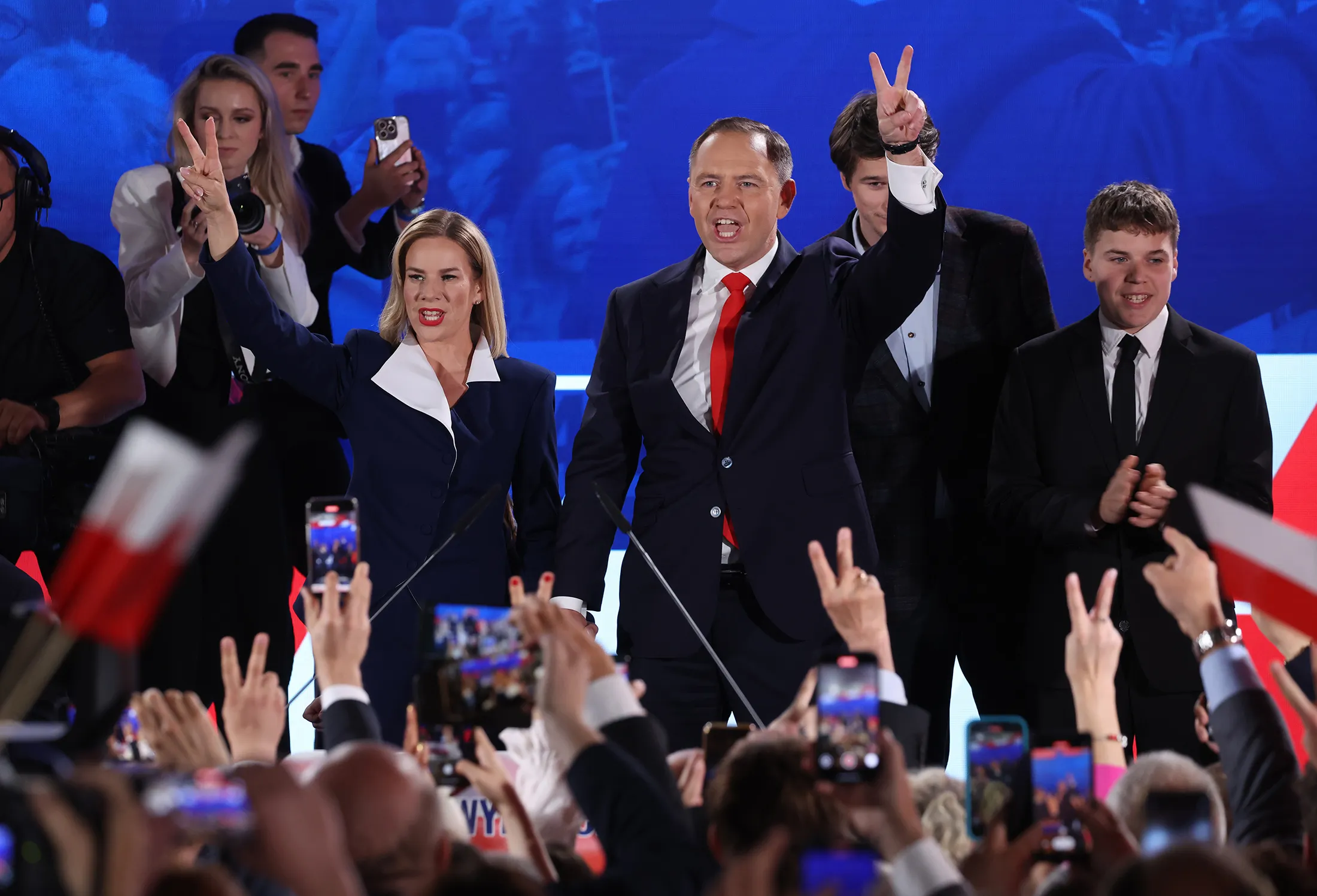 Karol Nawrocki, center, with his wife Marta and their children during an election night rally in Warsaw yesterday.