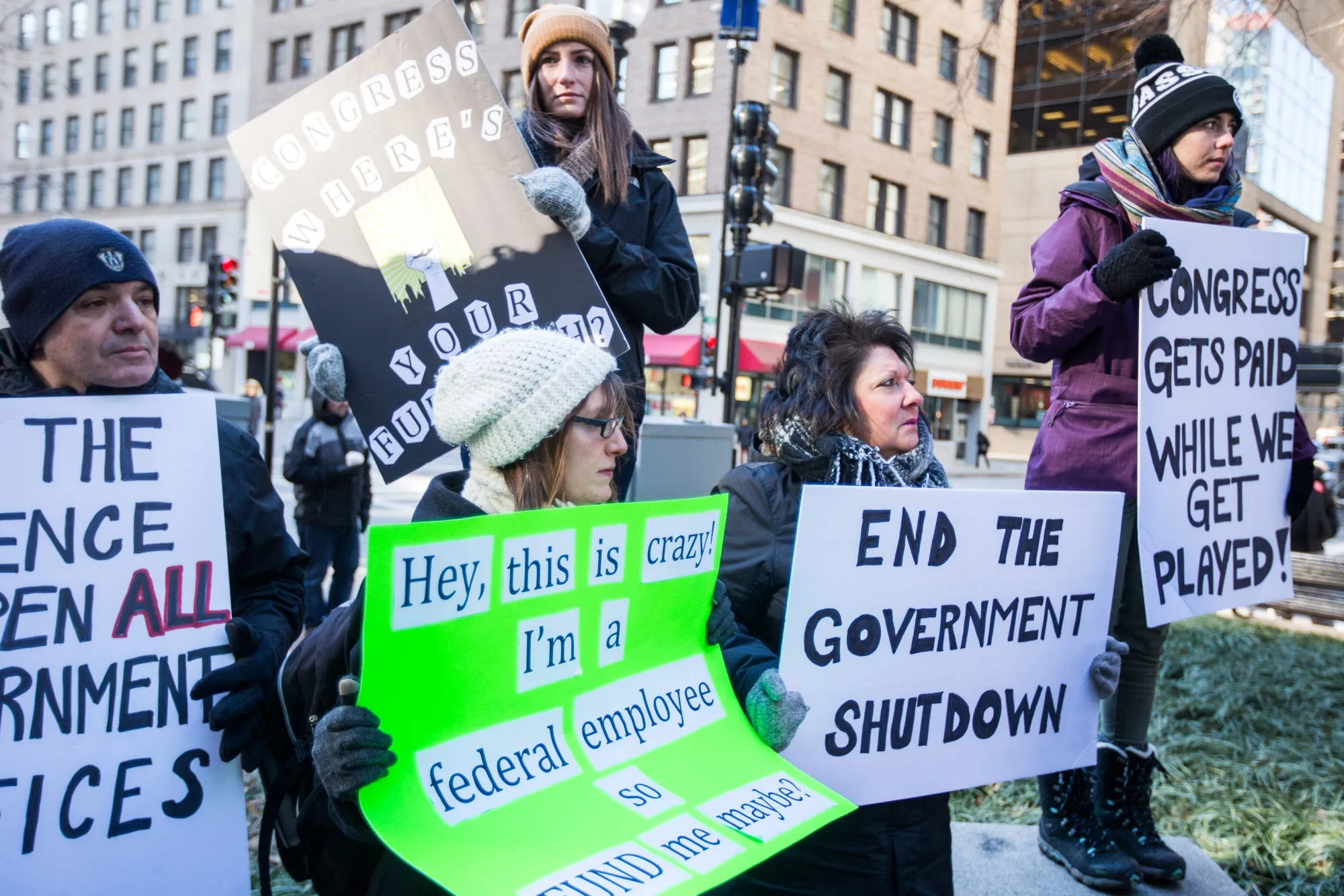 Demonstrators hold signs during a protest against the government shutdown in Boston on&nbsp;Jan. 11, 2019.