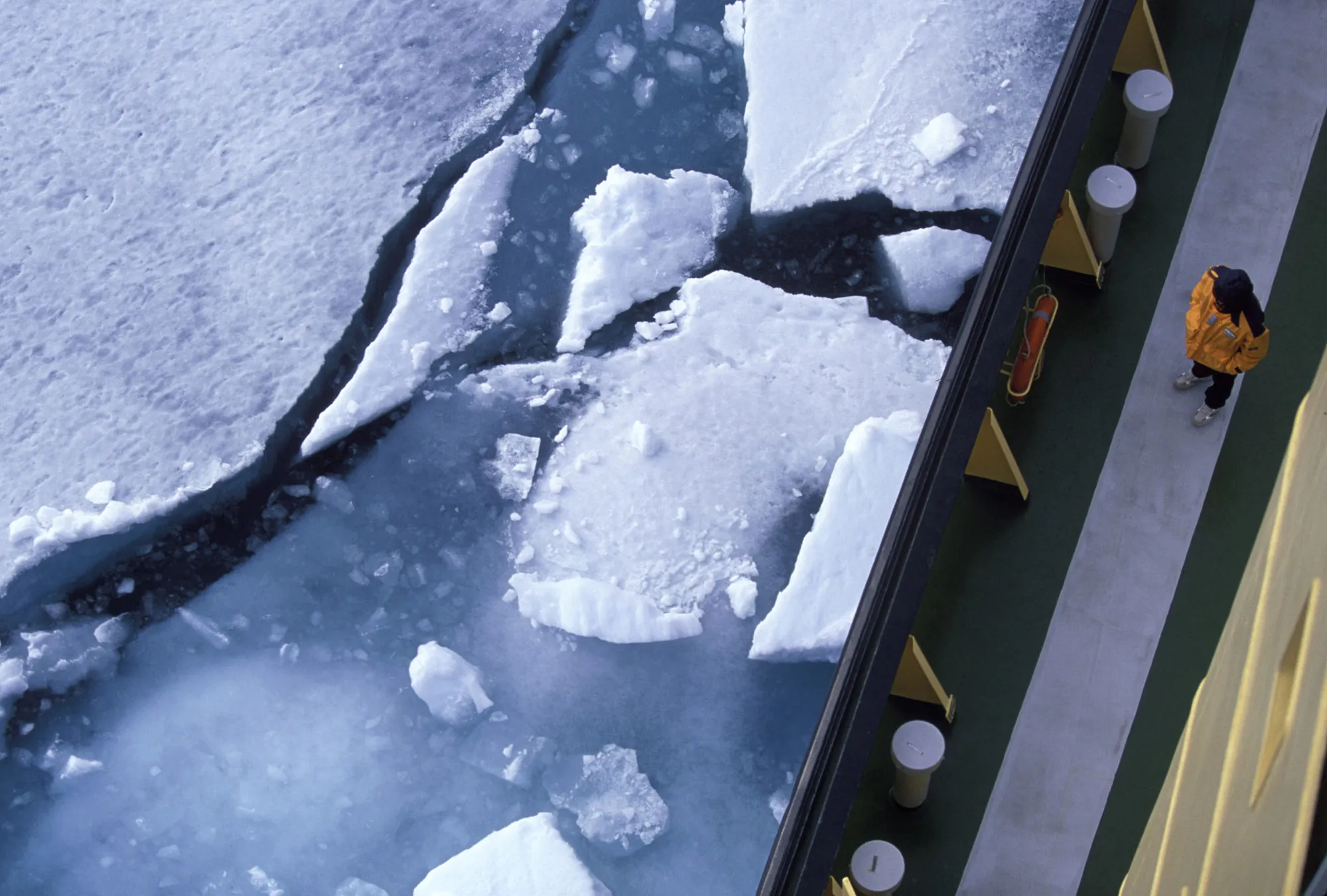 A passenger watches ice breaking from the deck of a&nbsp;Russian icebreaker ship&nbsp;in Radstock Bay.
