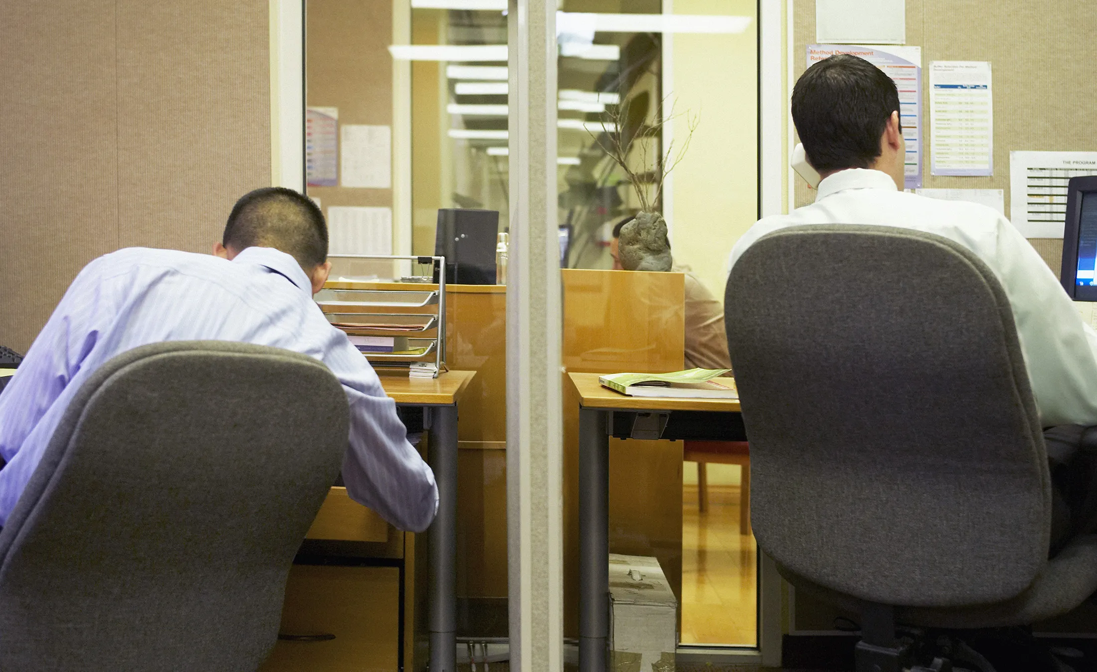 Men working at desks.
