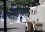 A demonstrator throws a tear-gas grenade against security forces during clashes in the capital on April 30.
