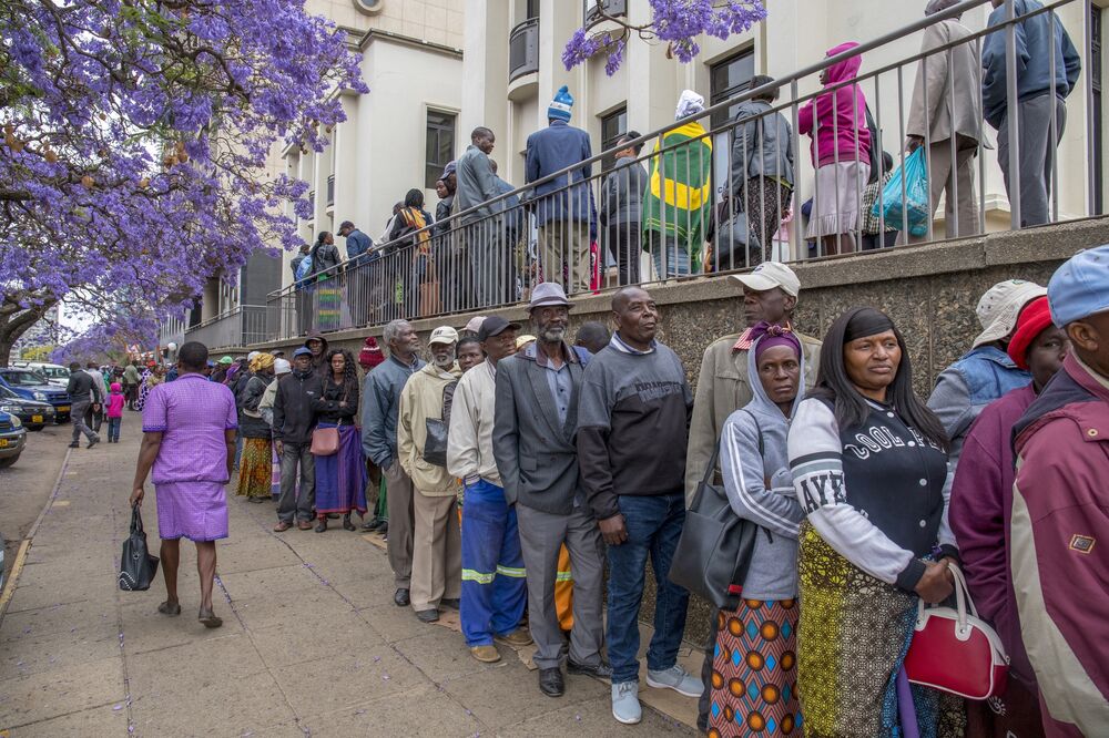 Pensioners line up to withdraw their pensions from a bank in Harare.