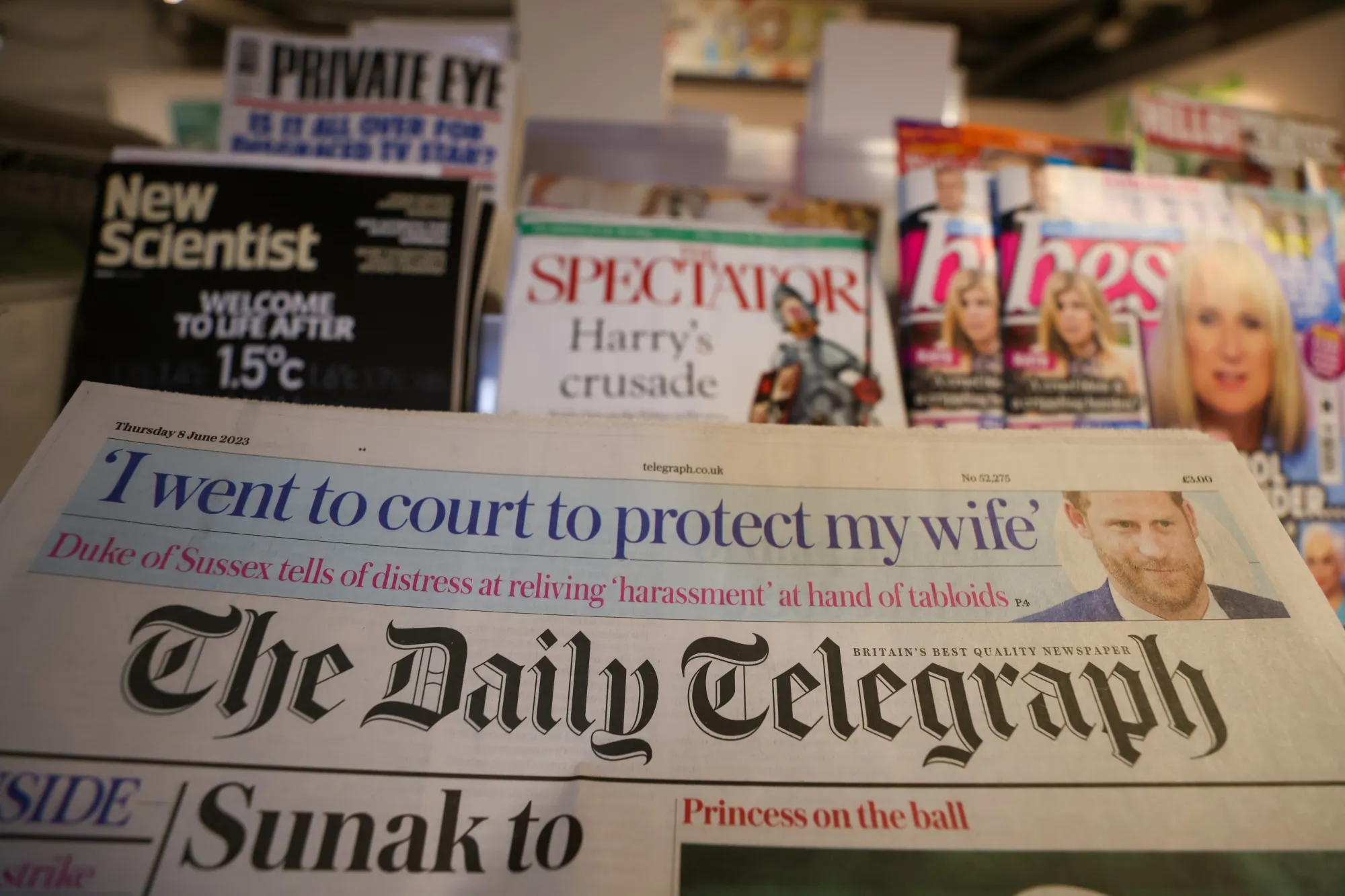 A copy of The Daily Telegraph newspaper and a The Spectator magazine on a newsstand in London, UK.