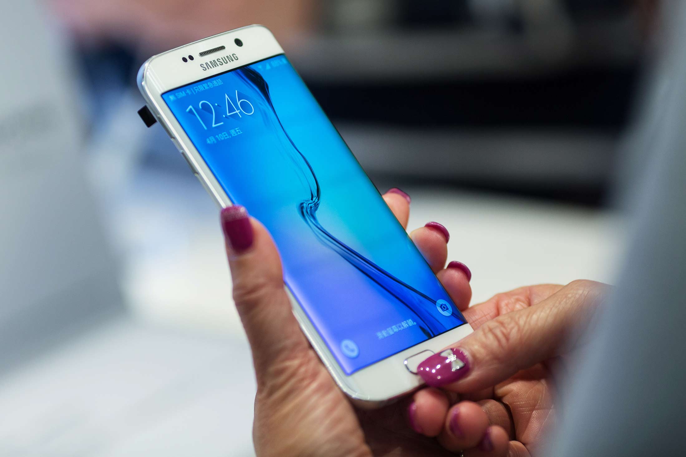 An attendee tries a Samsung Galaxy S6 Edge smartphone at a launch event in Hong Kong on April 10.
