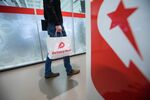 An employee carries a branded paper bag inside the Delivery Hero AG headquarter offices in Berlin, Germany, on Friday, Dec. 8, 2017. Delivery Hero competes with app-based takeout services including Just Eat Plc, GrubHub Inc. and Takeaway.com.