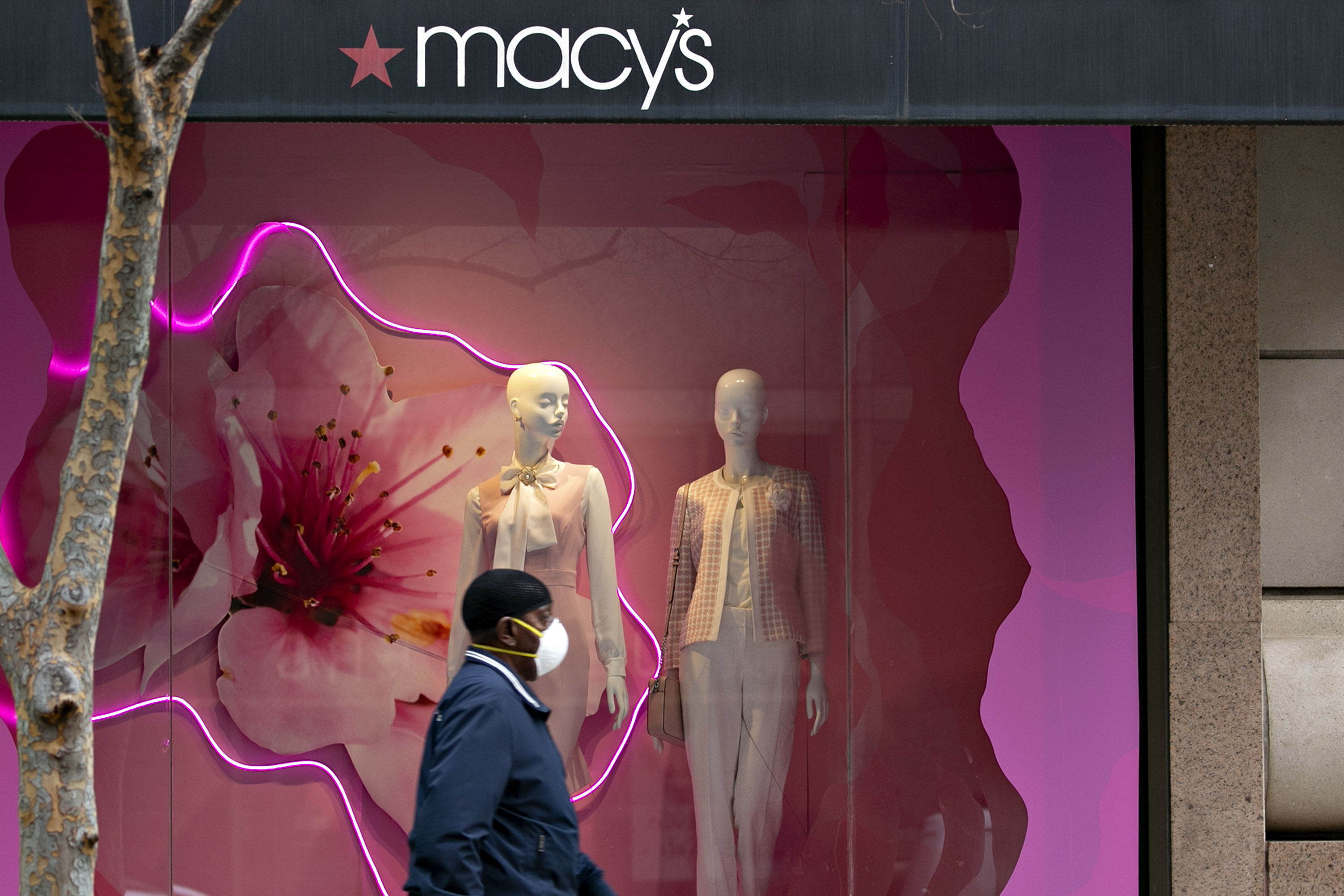 A pedestrian wearing a protective mask walks near a Macy's Inc. store in Washington, D.C., on&nbsp;March 31.&nbsp;