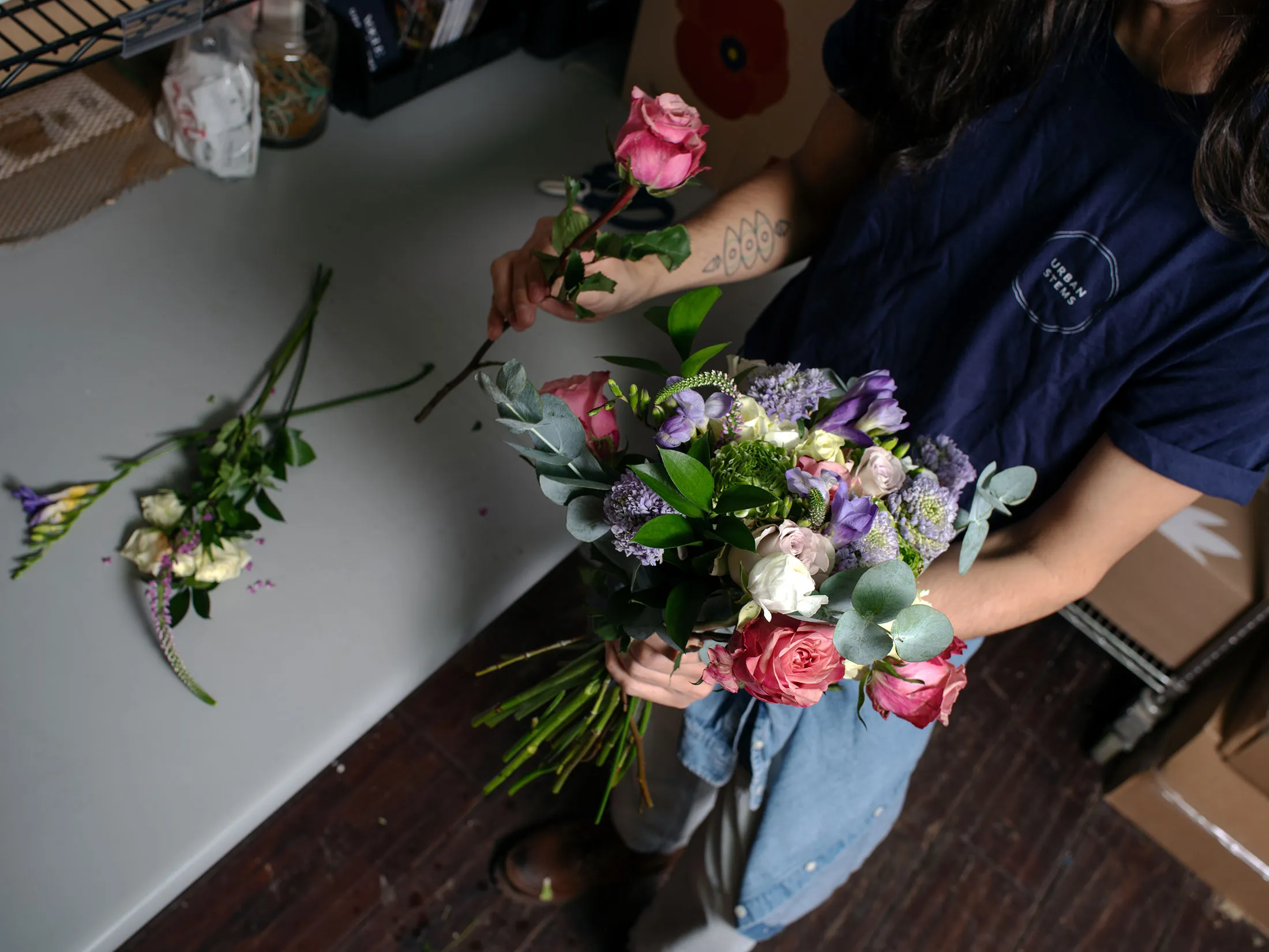 Floral design manager Justin Lievano prepares a bouquet at the New York distribution center for UrbanStems on Feb. 4.