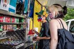 Customers wearing protective masks order from a food truck in Austin, Texas, U.S., on Thursday, June 25, 2020.