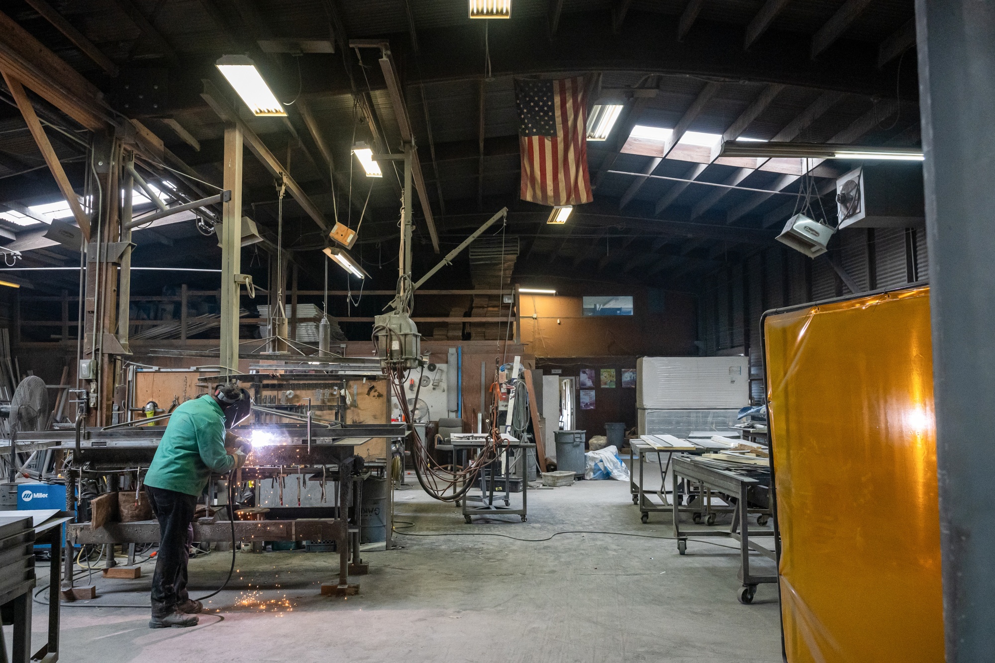 A worker arc welds a metal door in Sacramento, California.