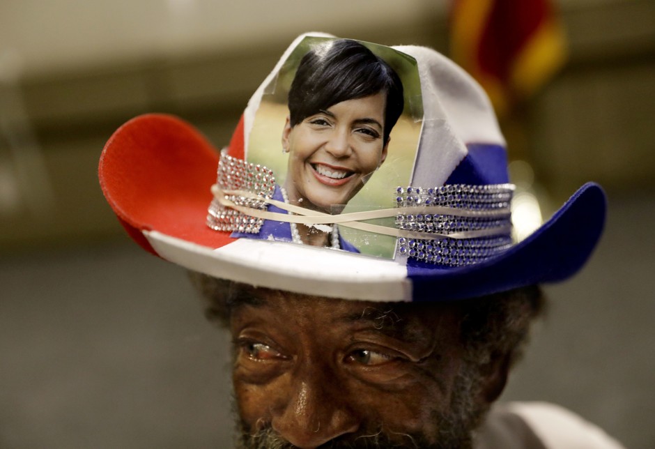 Charles Doyle wears a hat decorated with an image of Atlanta city councilwoman and mayoral candidate Keisha Lance Bottoms as she speaks at an election night party in Atlanta.