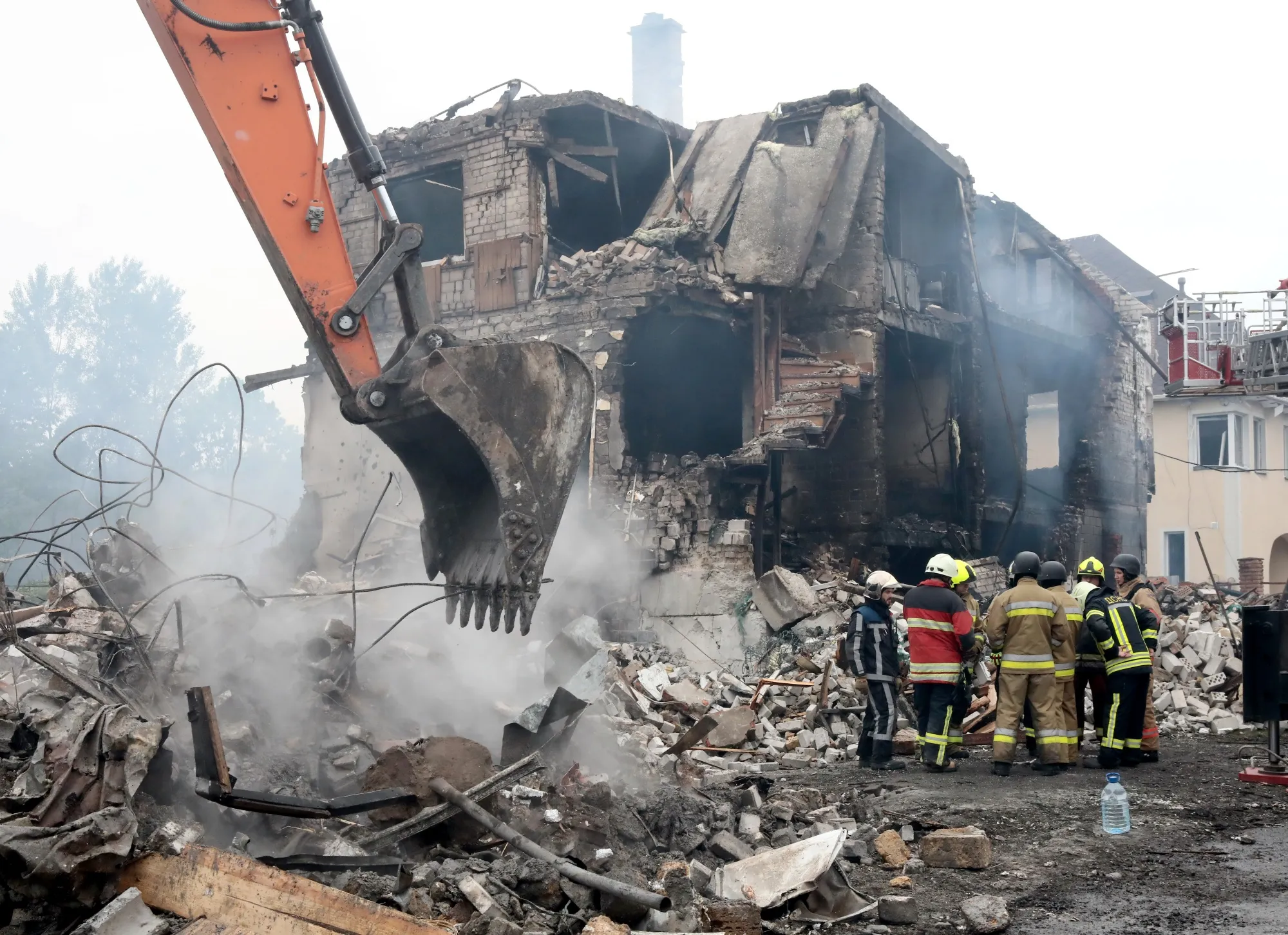 Rescuers&nbsp;outside a house destroyed by a Russian attack in Markhalivka village, Ukraine, on May 25.