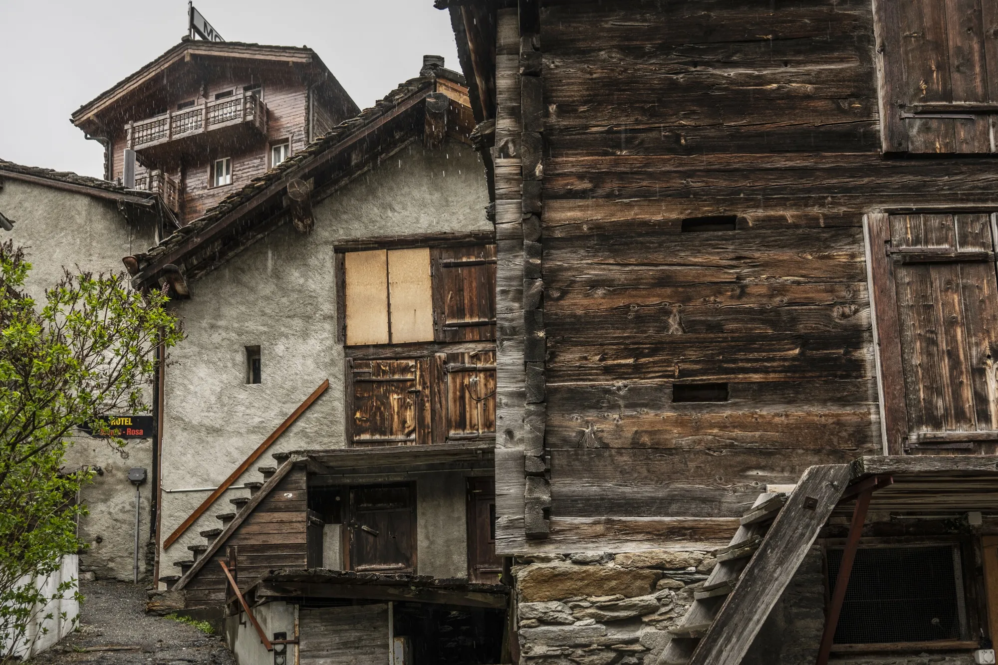 Another photo shows the traditional Swiss buildings in Saas-Grund, made of weathered wood.