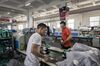 Workers work on the footwear production line at the Anta Sports Products Ltd. factory in Jinjiang, Fujian, China, on Tuesday, Aug. 27, 2019. Western companies still dominate China's $43 billion domestic sports apparel market, where Nike's share is almost 23%, Adidas holds 20% and Anta is third, with 15%. Anta President James Zheng predicts it will be the country's dominant sportswear brand by 2025. The rest of the world will get to know it, too, he says. One reason: Two years ago, NBA star Klay Thompson agreed to a 10-year, $80 million extension of his endorsement deal with the company.