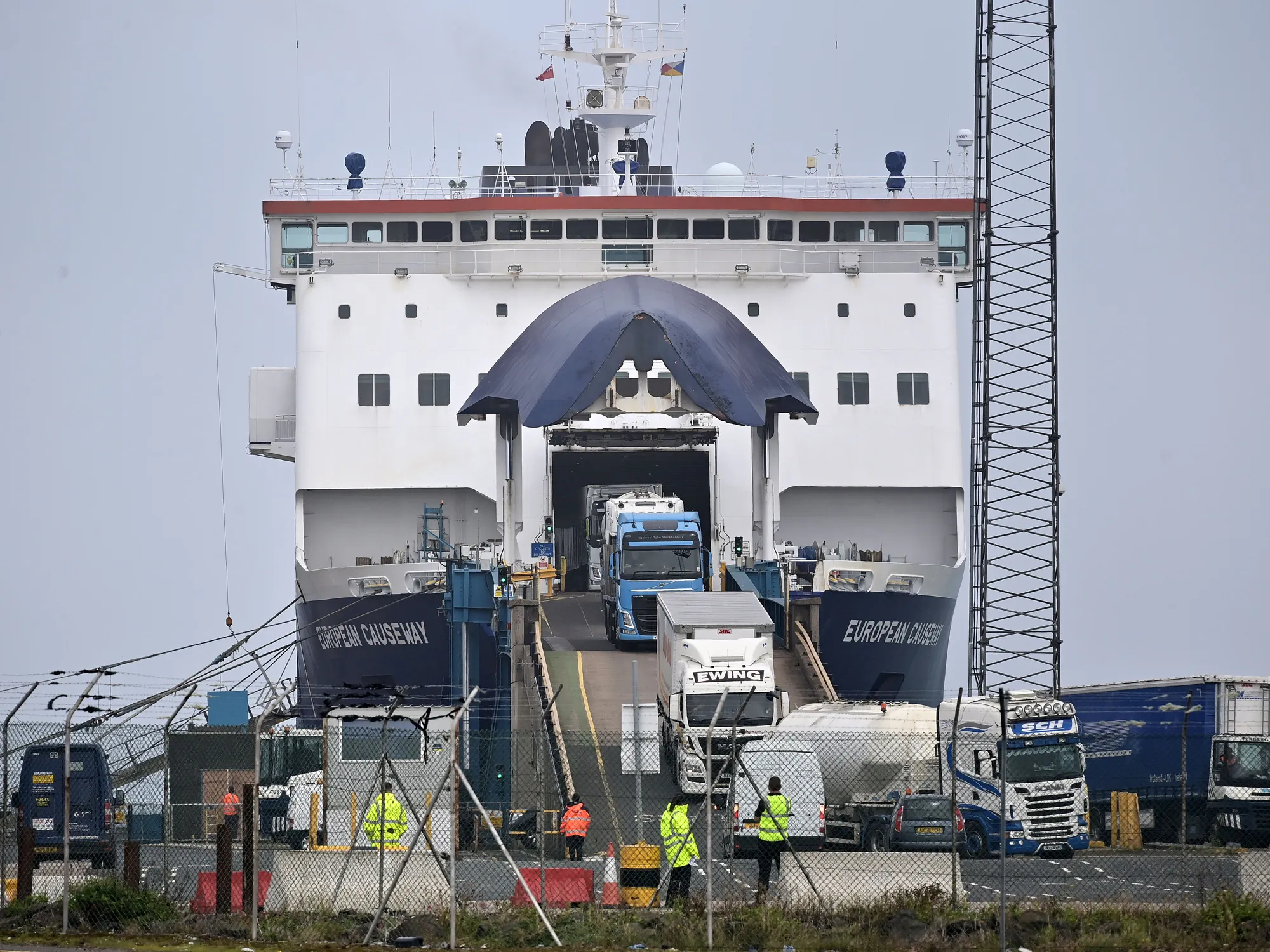 Customs and border officials watch on as freight disembarks at Larne harbour, Northern Ireland.